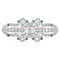 An Art Deco diamond and emerald double clip brooch