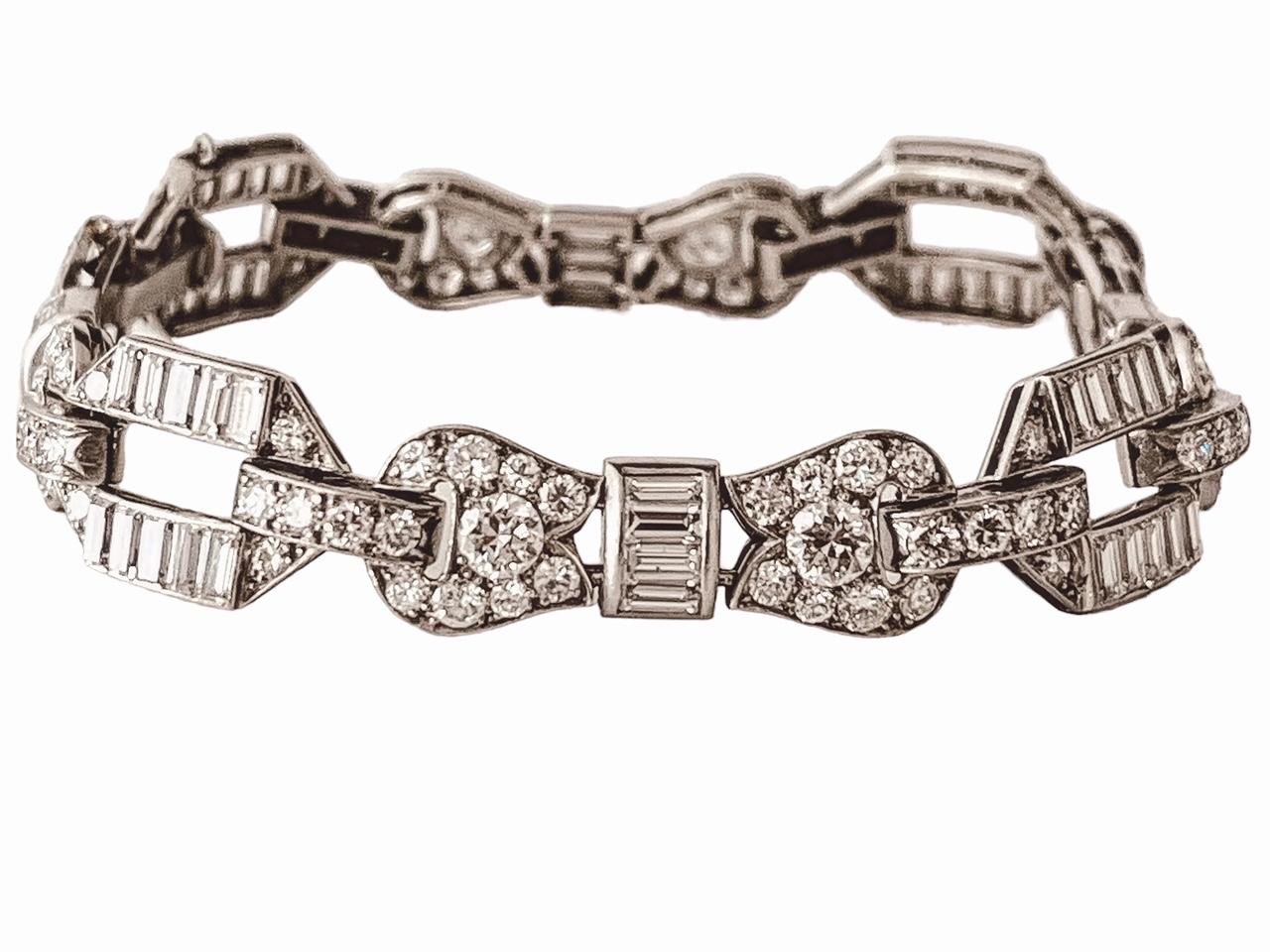 An Art Deco diamond bracelet. Set throughout with baguette and road-cut diamonds. Circa 1930s. Approximately 12cts of diamonds in total. 20.4cm in length and 1.1cm wide. 33.7 grams . Set in platinum. Price: 33,160£. Item is in very good condition