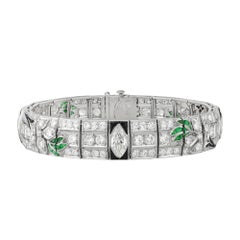 An Art Deco diamond, emerald and onyx bracelet