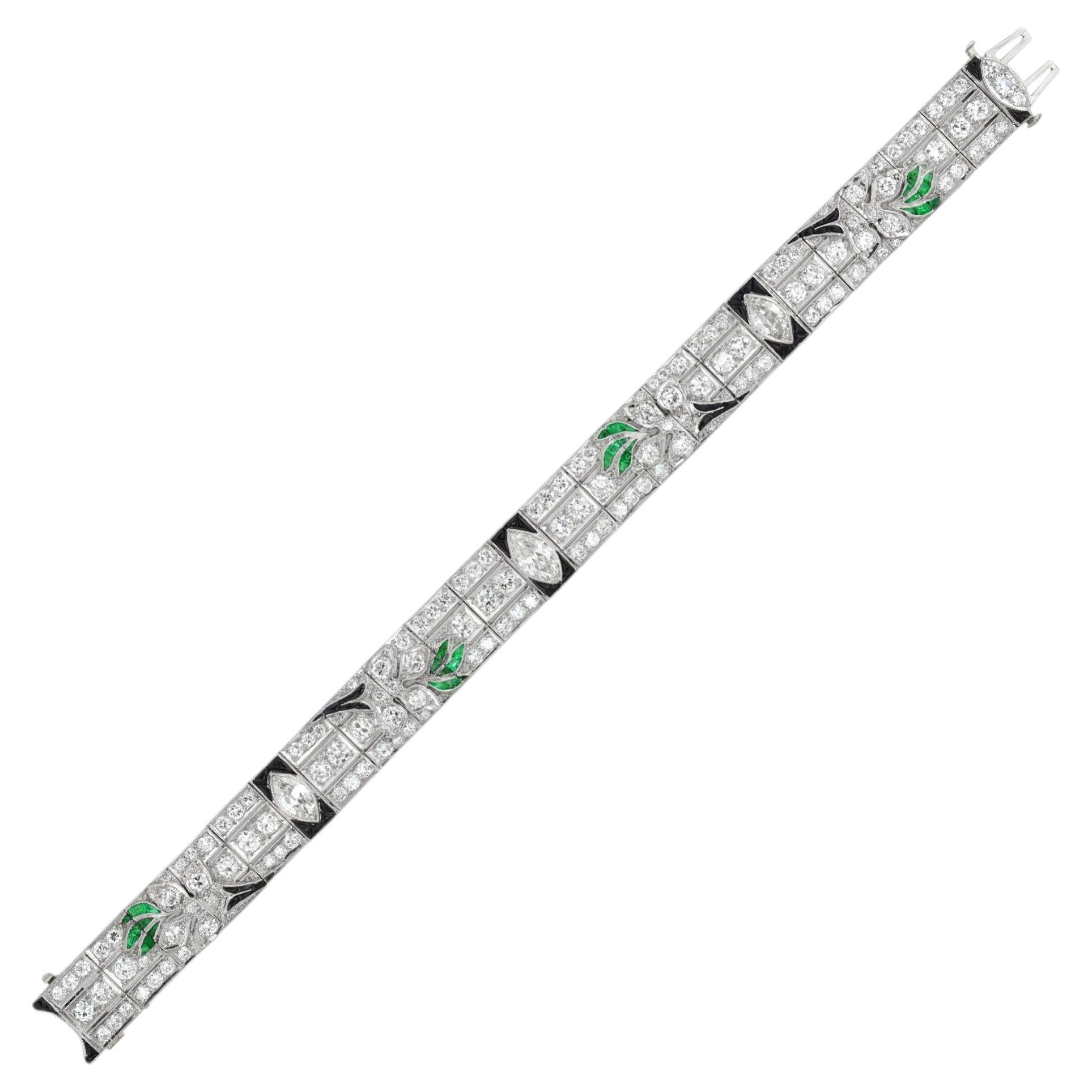 An Art Deco diamond, emerald and onyx bracelet