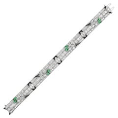 An Art Deco diamond, emerald and onyx bracelet