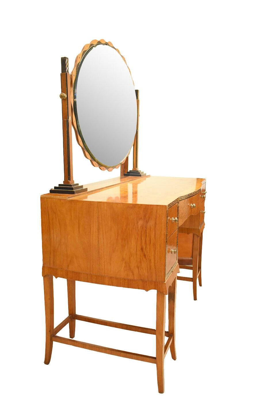 A beautiful Art Deco dressing table by Herbert Richter for Bath cabinet makers.

Made from Burr walnut and ebonized and mother of pearl inlaid details. 
Really beautiful piece, would look amazing in any dressing room or bedroom.