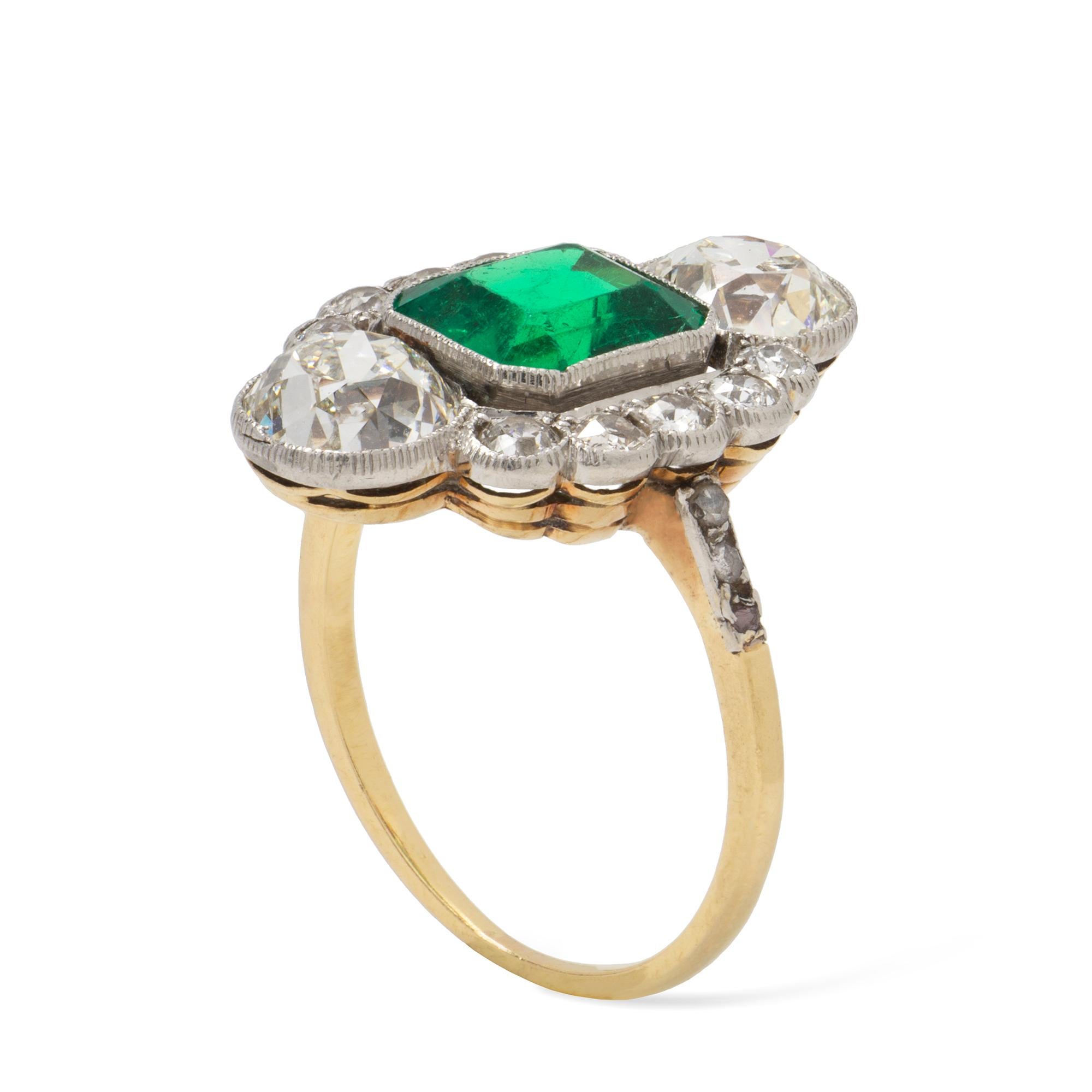 An Art-Deco emerald and diamond ring, the octagonal-cut emerald weighing approximately 2.1 carats accompanied by GCS Report stating to be of Colombian origin, surrounded by ten round old-cut and two old cushion-cut diamonds weighing approximately a