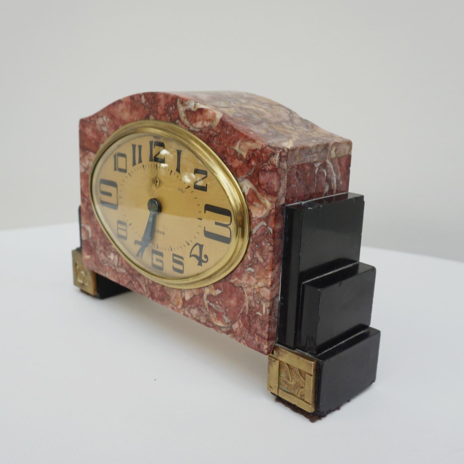 An Art Deco mantle clock by DEP, France. Eight day movement, stylised numerals set in pink marble. 

Origin: French

Date: circa 1925

Item Number: 1003234.