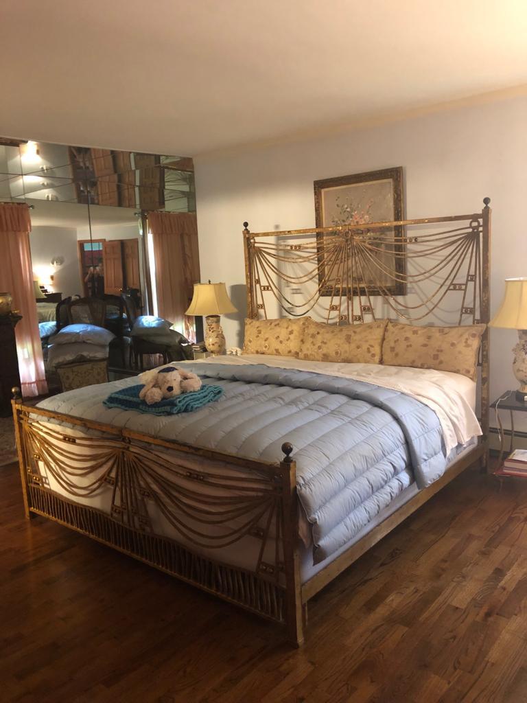 An Art Deco architectural gilt metal tassel kings sized bed frame. This simply stunning distressed gilt metal over ebony bed-frame comes complete with side rails and underside supports. The chain drapery form design is sleek and elegant as the