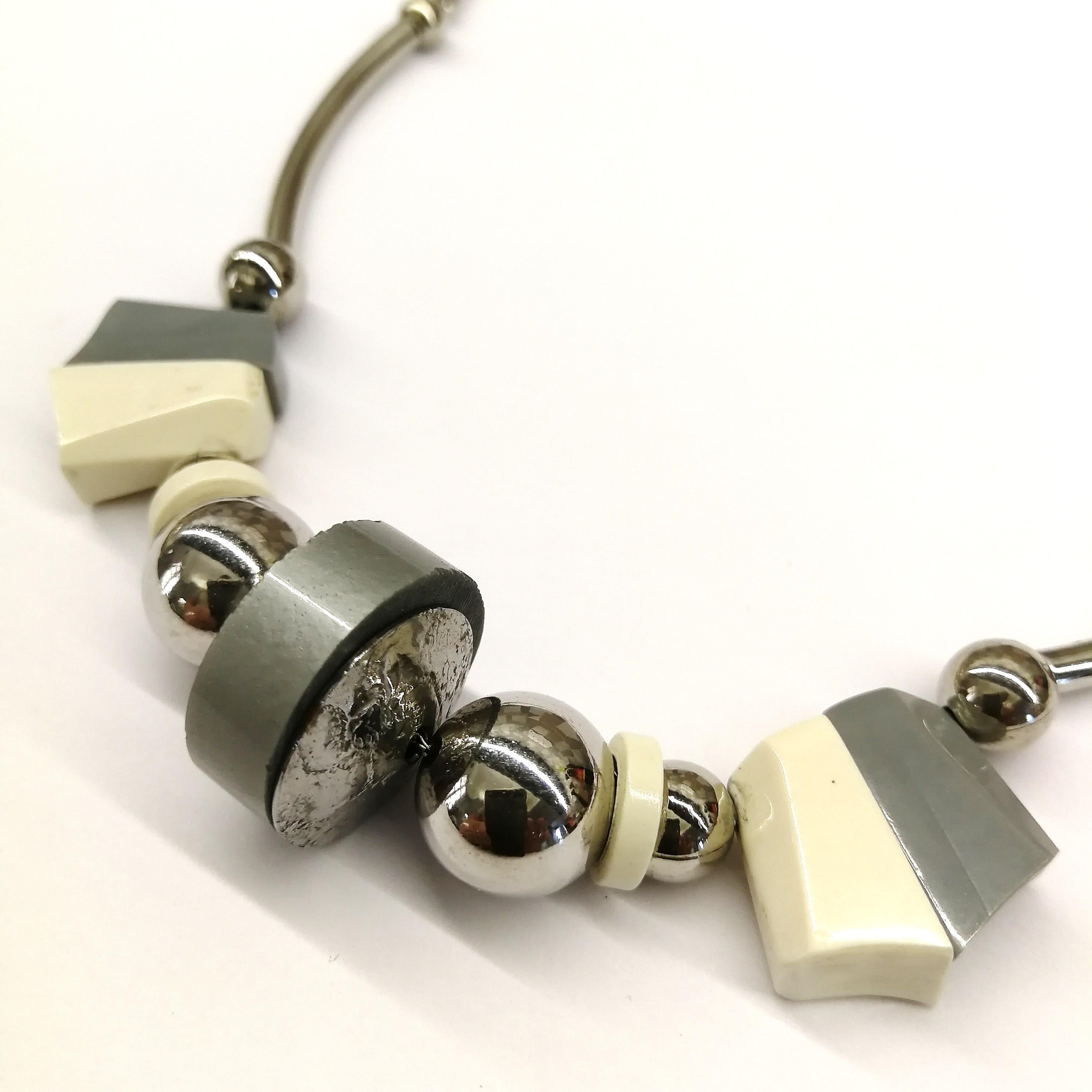Typical of so much design that came out of Germany in the 1920s and 1930s with the explosion of Art Deco, this attractive Machine Age necklace is a prime example. In complementing tones of soft grey and cream, highlighted with chrome fittings