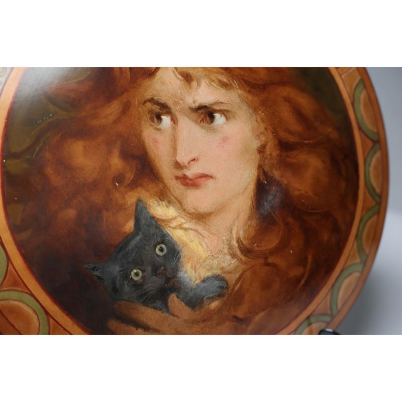 An Art Deco hand painted plate depicting Lois the Witch holding a black cat. 10