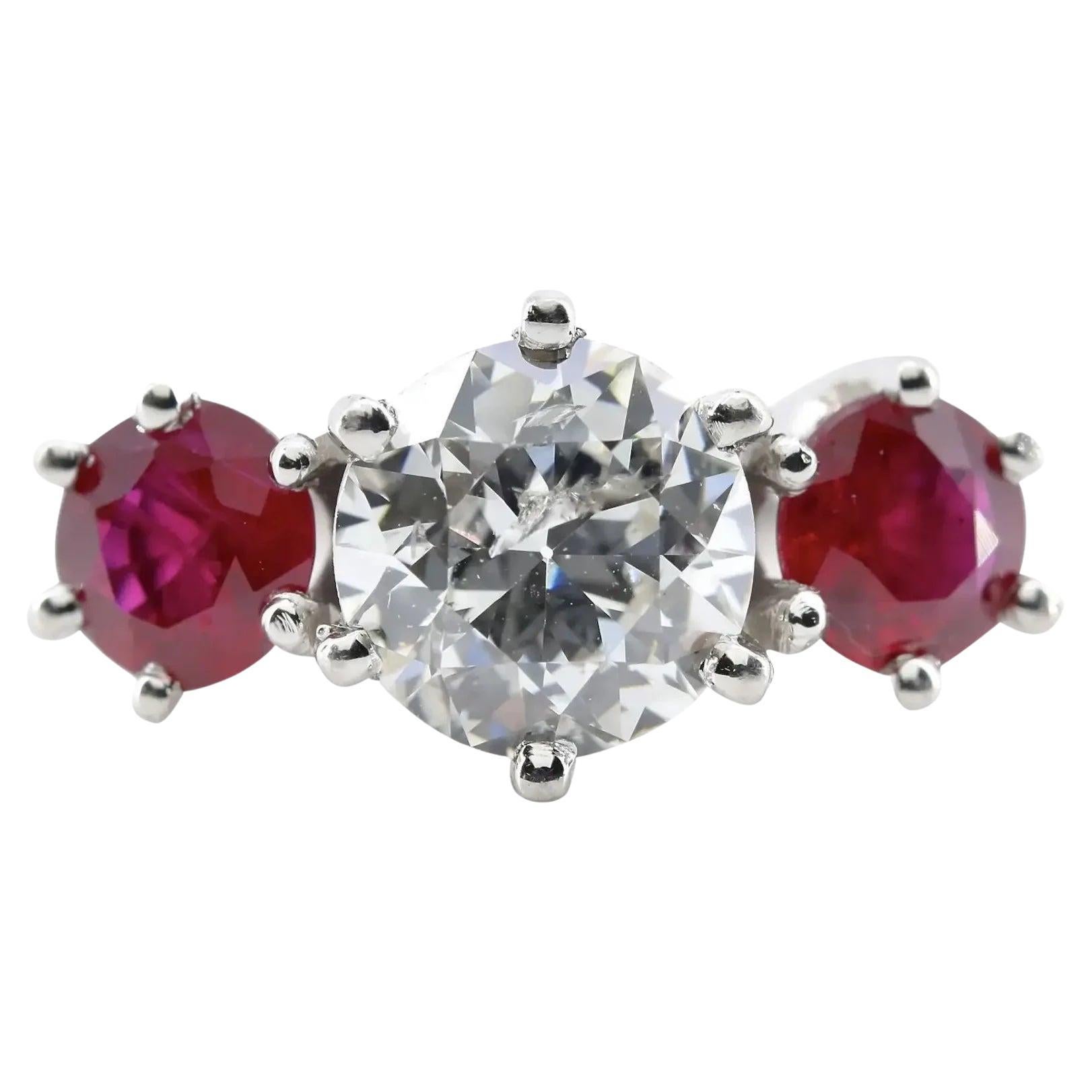 An Art Deco inspired diamond, and ruby dome style ring in platinum.  Centered by For Sale