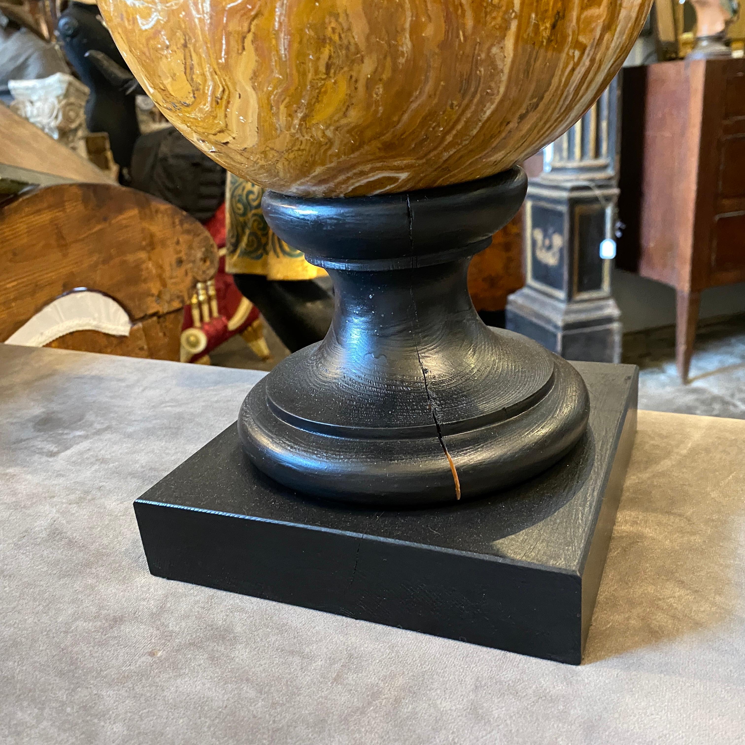 An onyx marble sphere in perfect conditions, it has been mounted on a black wood base in the Thirties.