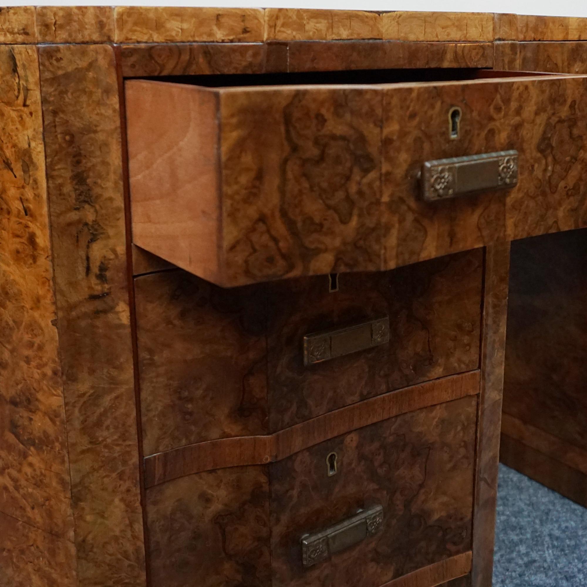 An Art Deco kidney shaped desk. Burr walnut veneer on solid mahogany with original handles.

Dimensions: H 78cm W 134cm D 63cm, Knee H 60.5cm W 53.5cm

Origin: English

Date: Circa 1935

Item Number: 27102313