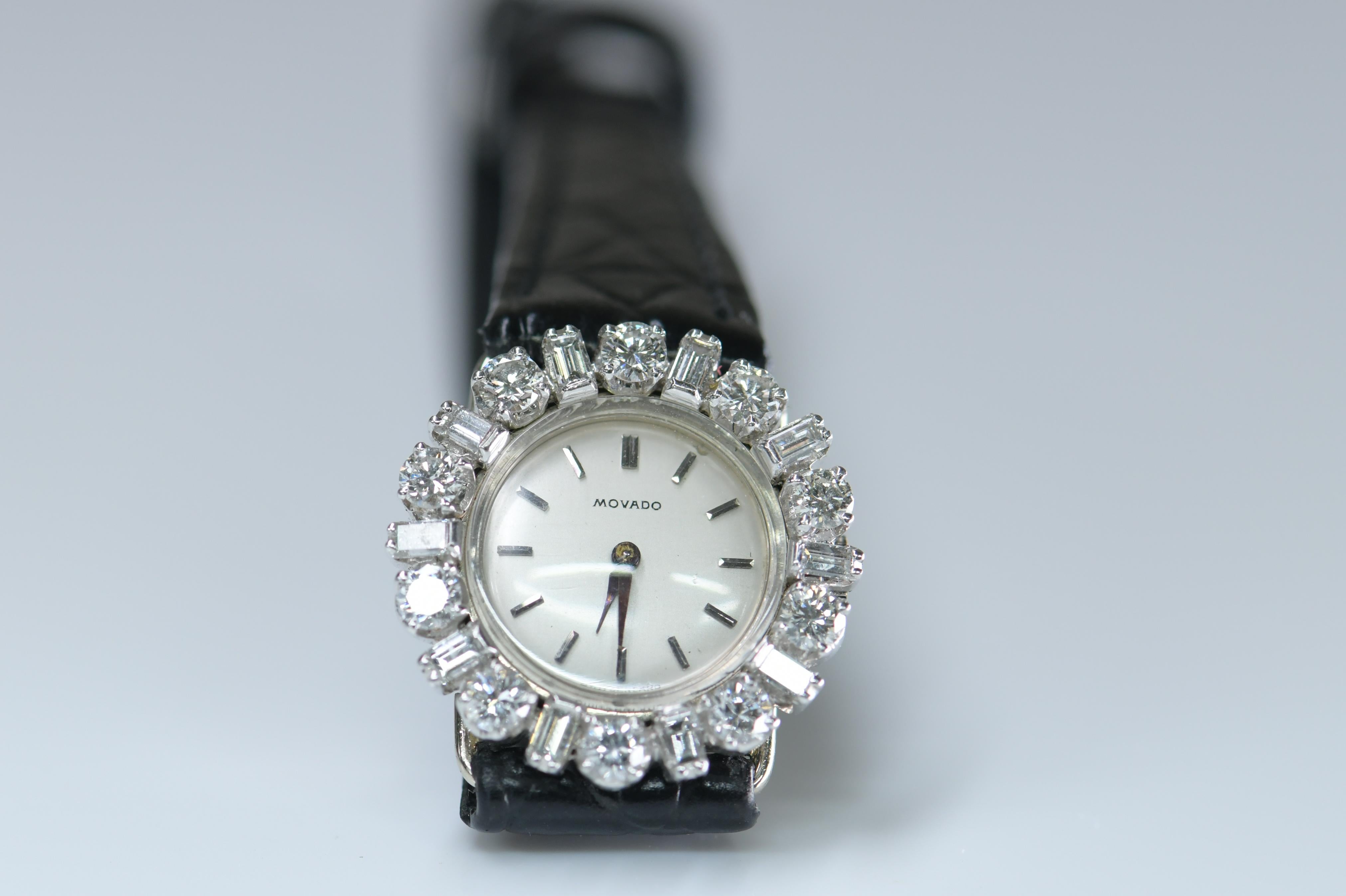 This stunning and sophisticated Art Deco bracelet watch, crafted in 18k white gold and sparkling with bright-white diamonds.

The round dial enhanced by round and Baguette-cut diamond scrolling shoulders and a leather strip bracelet; dial and