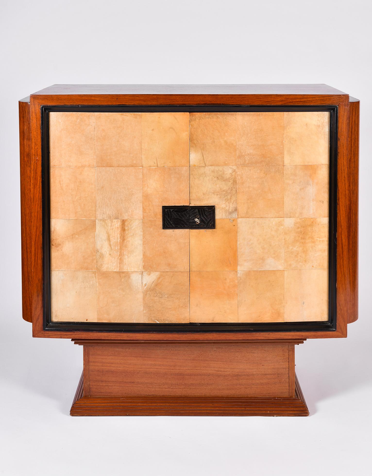 An Art Deco mahogany and velum cabinet,
The two door clad in velum revealing a shelf and a drawers, adorned with intricate geometric marquetry and clad in velum.
France, circa 1930.