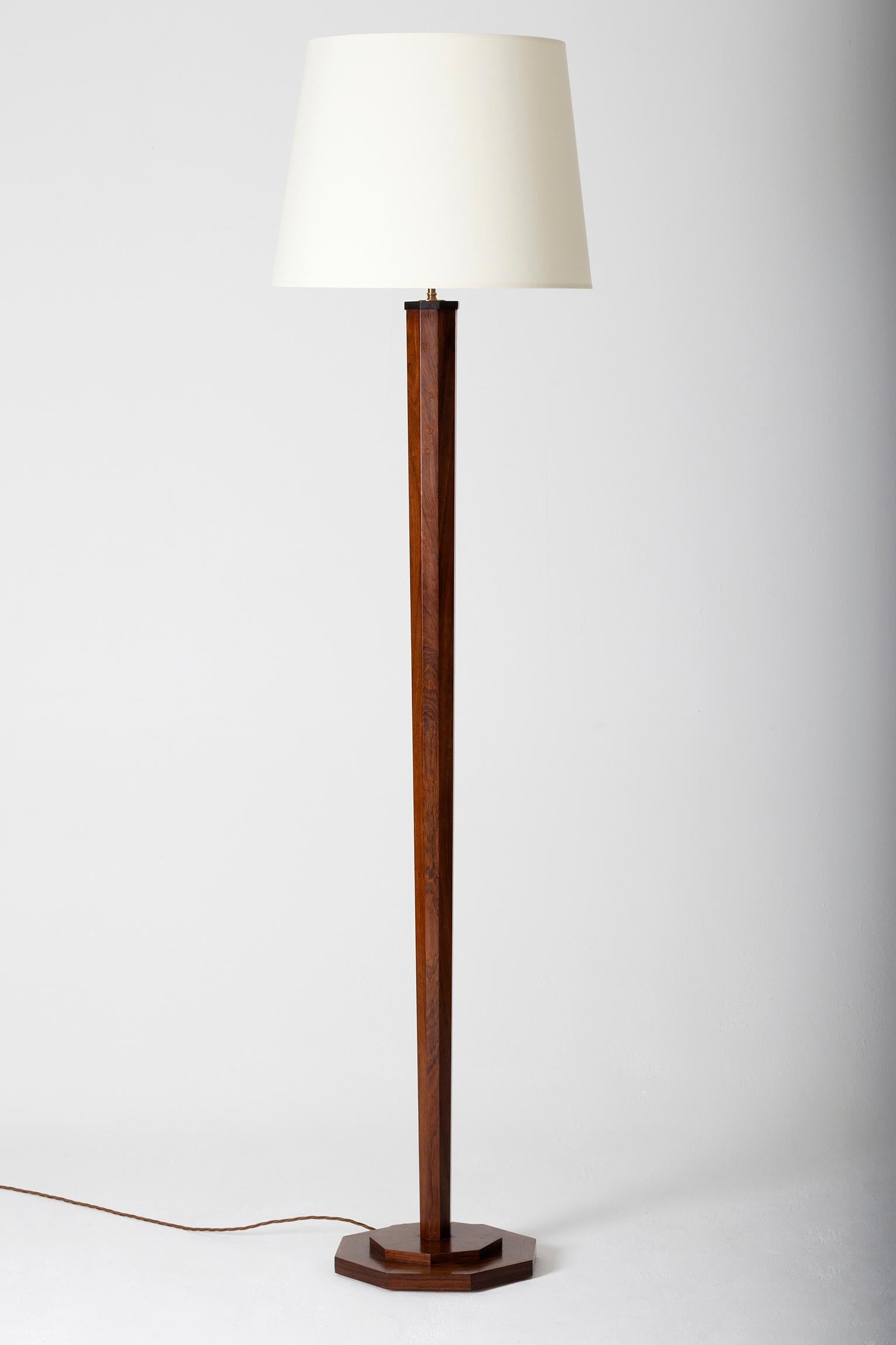 An Art Deco mahogany veneer floor lamp,
The octagonal stepped base supporting a tall tapering and faceted stem.
France, circa 1930
Measures: Including the shade 196 cm tall by 51 cm diameter
Lamp base only 157 cm tall by 33 cm diameter.