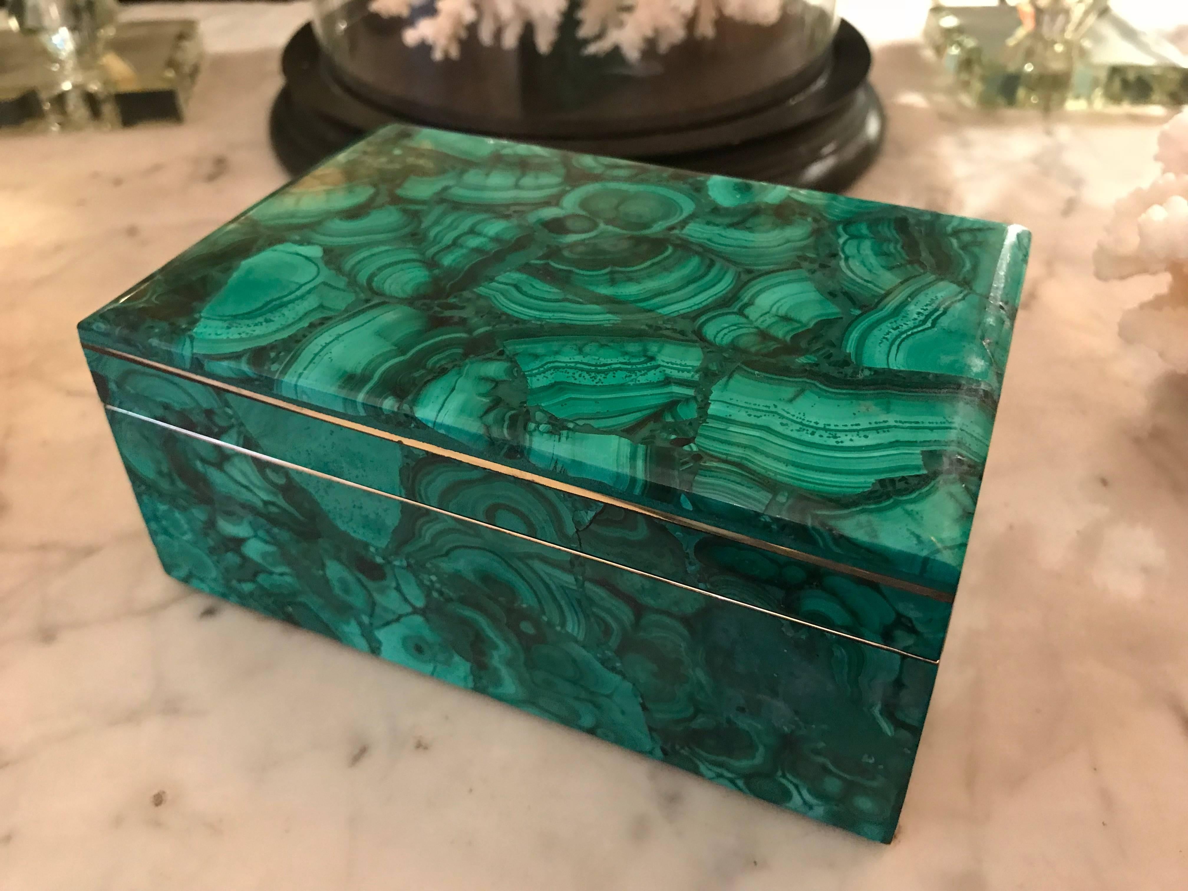 A beautiful malachite jewelry box with brass trim inlaid on the lid and around the base top. A beautifully quality vintage piece from the 1930s.