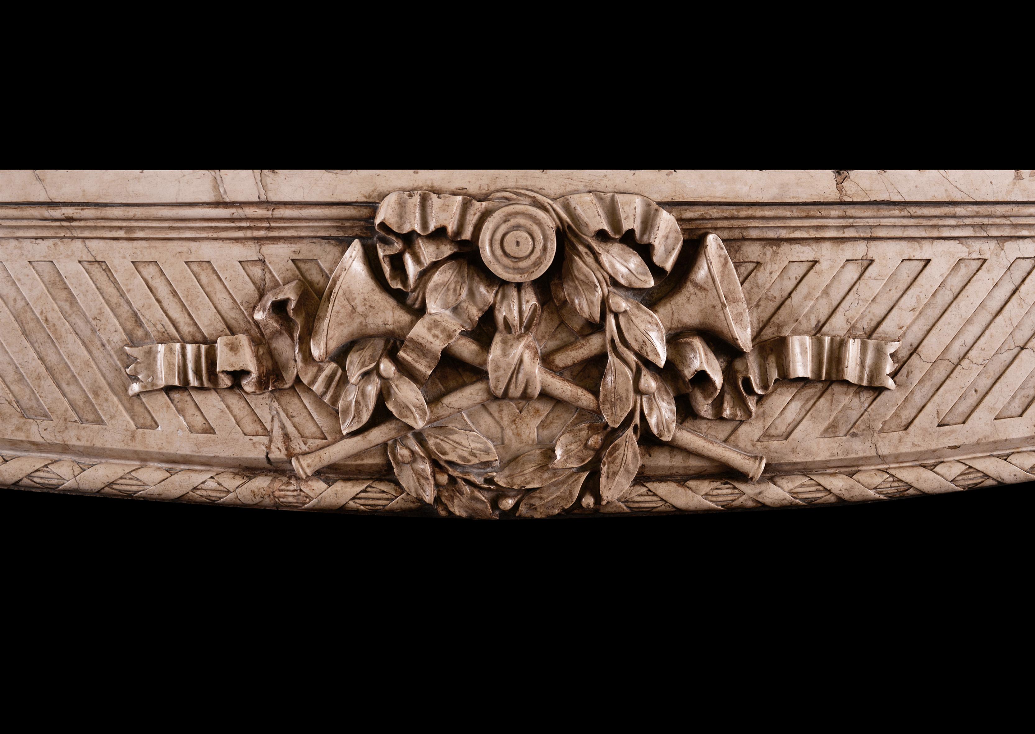 A good quality Art Deco marble fireplace with a French Louis XV influence. The jambs with carved inner rope moulding, carved wreaths and berries, tied with ribbons. The frieze with wreath, ribbons and musical instruments. Moulded shelf above.