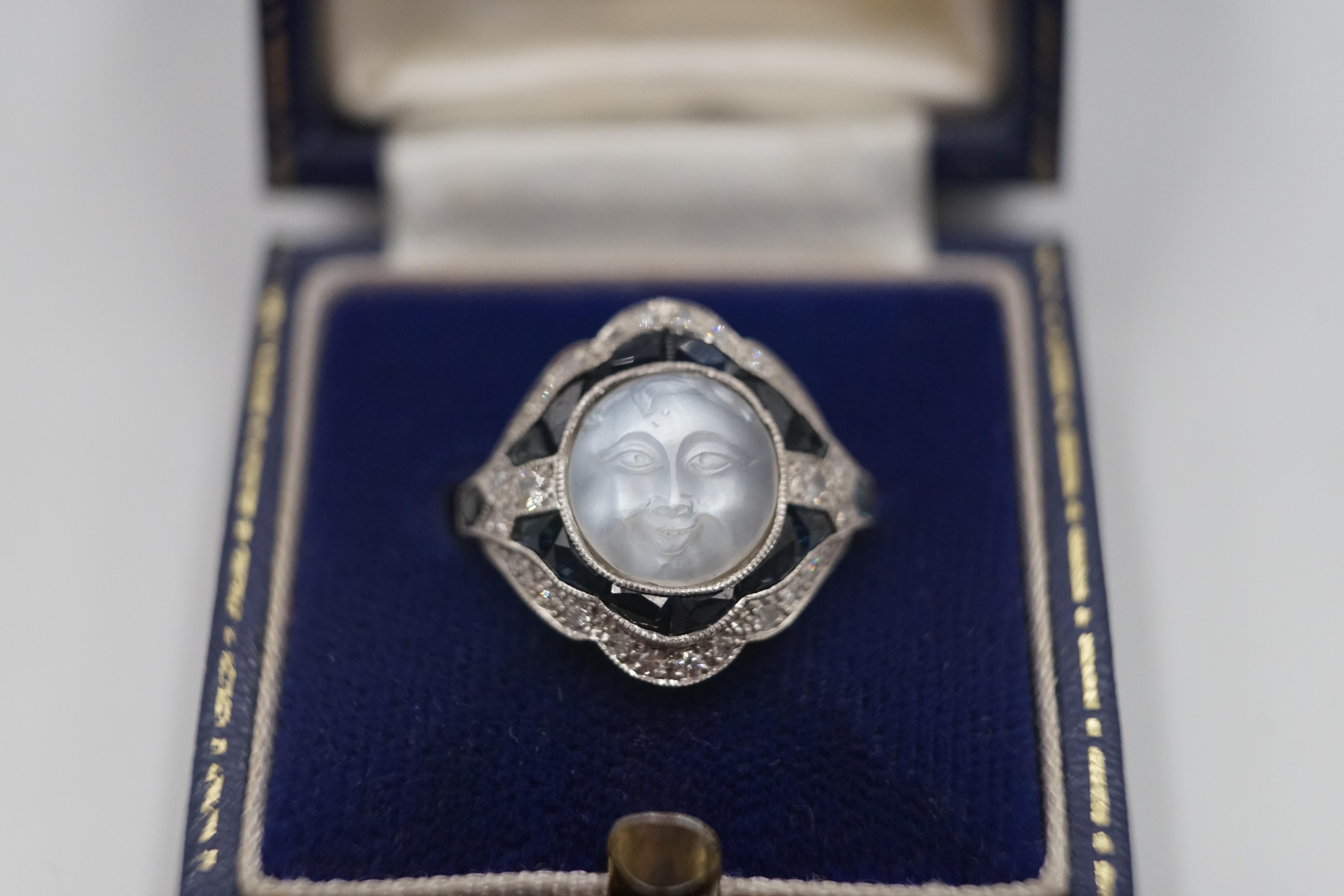 A fantastic antique carved moonstone face. shimmers in the light and reflects the sun.

This piece is crafted in platinum and in the centre a delicately hand-carved to portray the 3-dimensional face of 