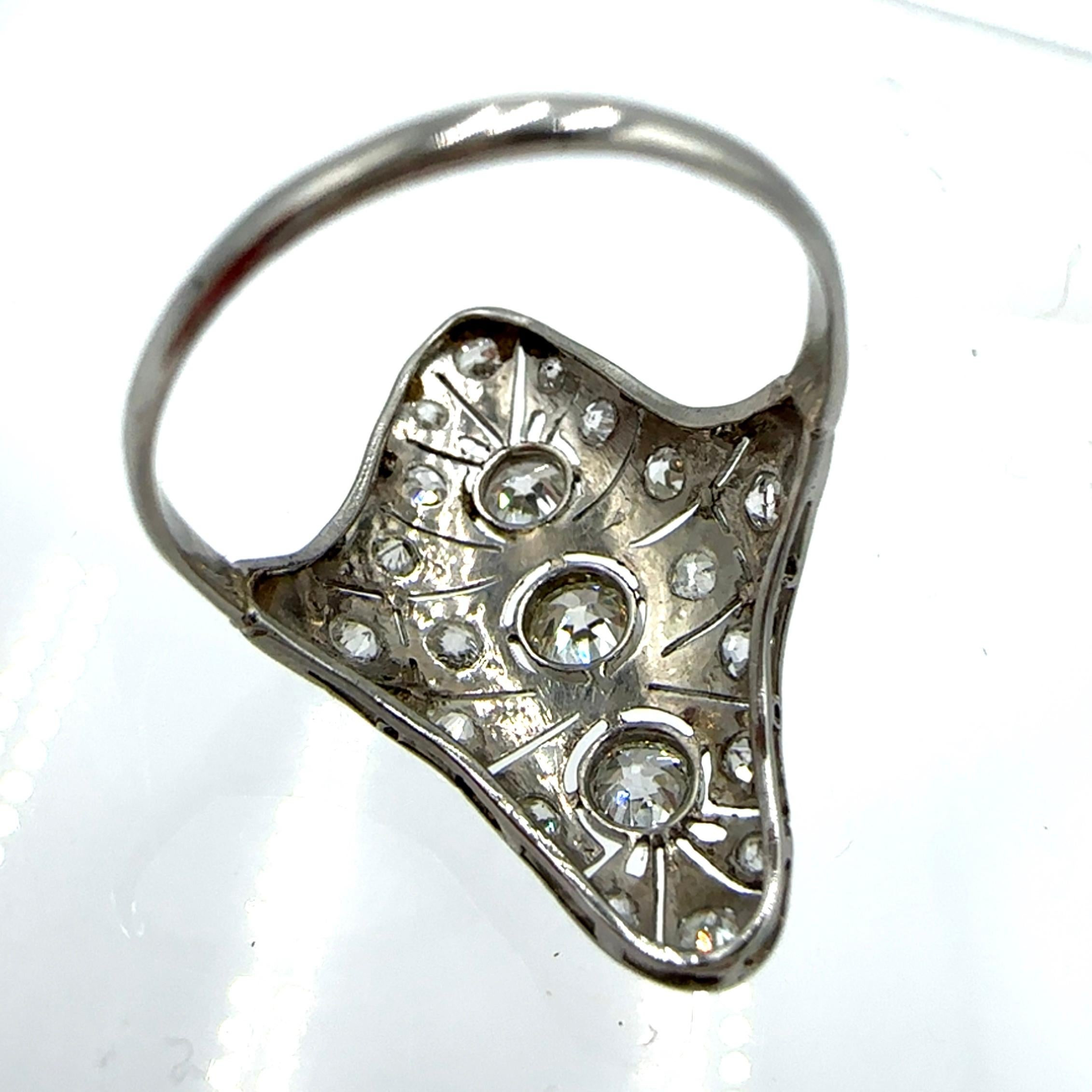 A sweet Art Deco diamond ring crafted in platinum. It features 0.80 carat total weight of natural mine cut, SI1-I1 clarity, I-J color diamonds. The detailing on this piece is truly amazing. It has great finger coverage making it a statement piece!