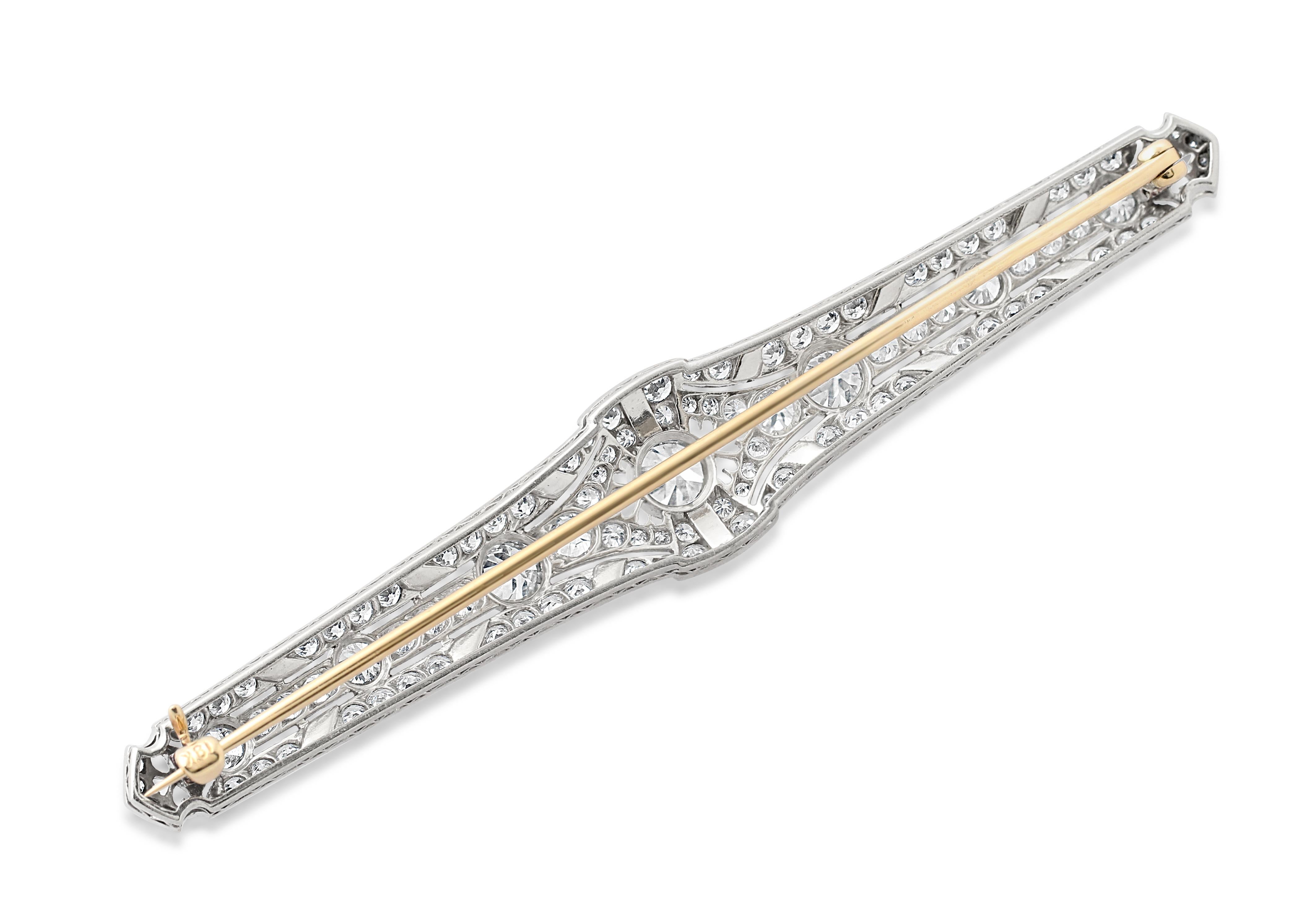 An Art Deco platinum, diamond and onyx bar brooch. Set with approximately 2.80 carats of diamonds and an 18k gold pin. Length = 8.5cm. Weight = 12.85gr.