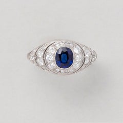 An Art Deco Platinum Sapphire and Diamond Cluster Ring