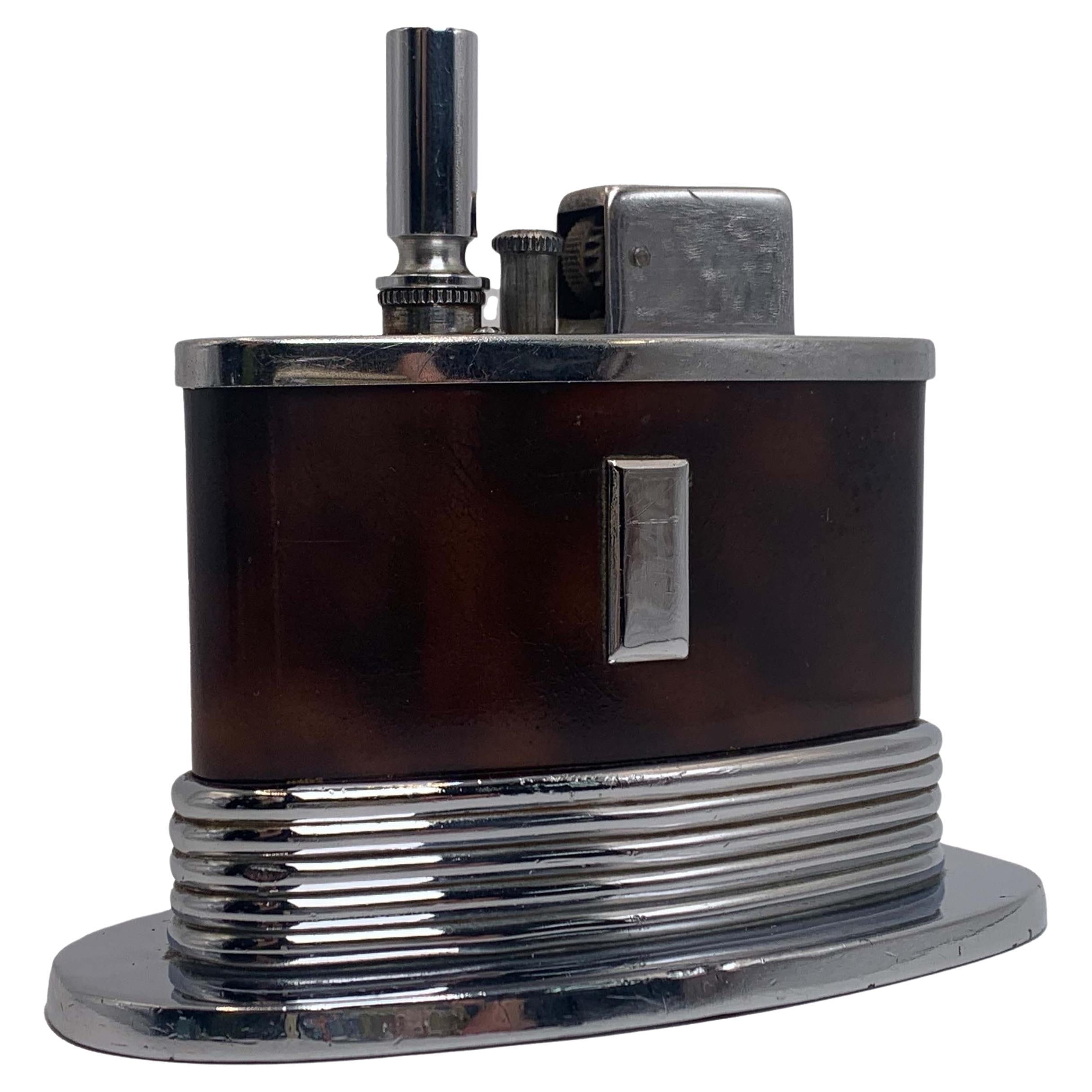An Art Deco Ronson Oval Touch Tip Table Lighter With A Tortoise Shell Finish