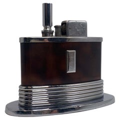 An Art Deco Ronson Oval Touch Tip Table Lighter With A Tortoise Shell Finish