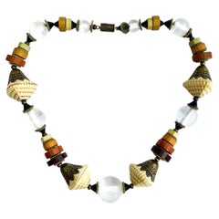 An Art Deco rope of assorted coloured Galalith and glass beads, France, 1920s.