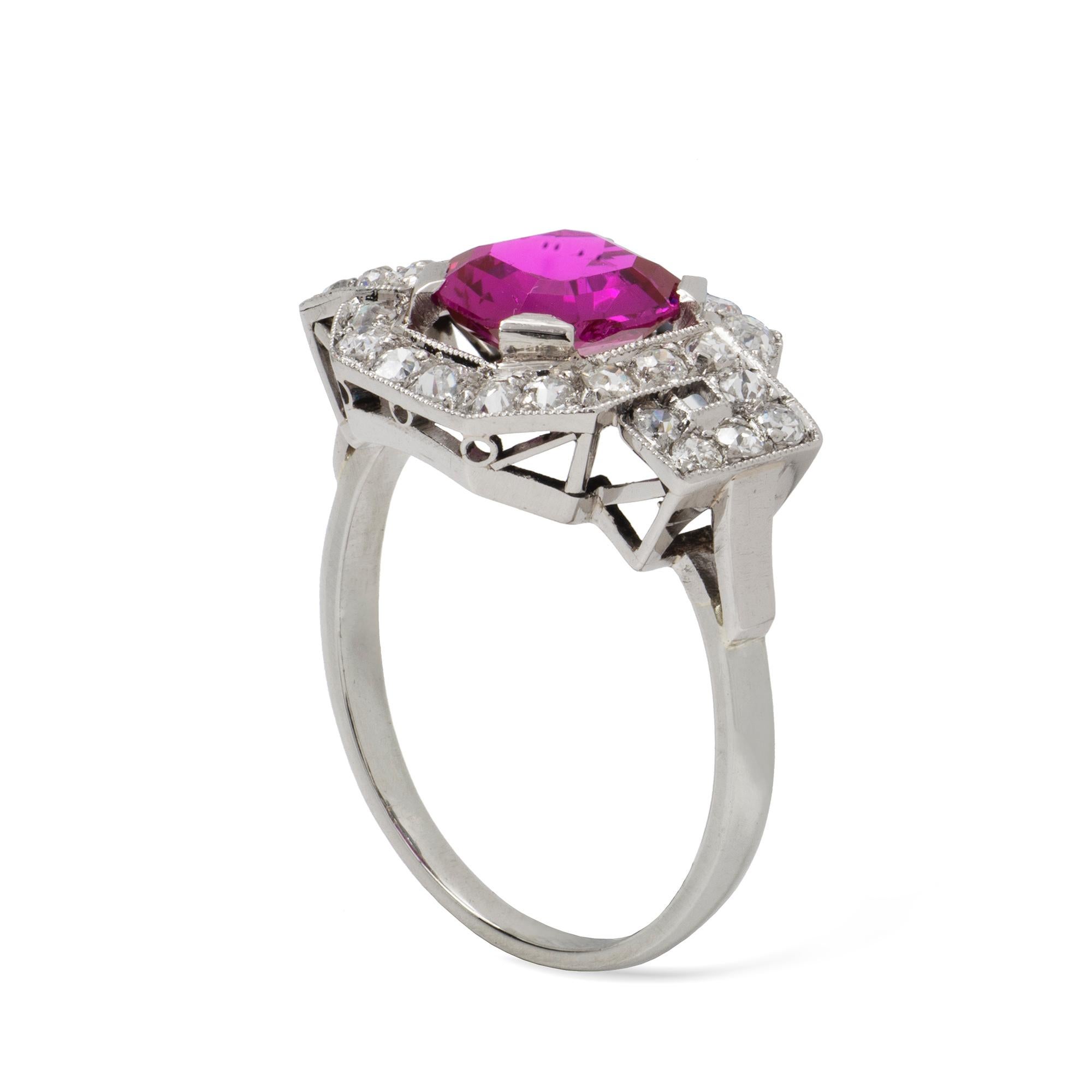 An Art-Deco ruby and diamond ring, the octagonal-cut Burmese ruby weighing 1.90 carats, surrounded by an openwork old cut and swiss-cut diamond-set frame, the diamonds estimated to weigh approximately 0.85 carats, all set in platinum,  circa 1920,