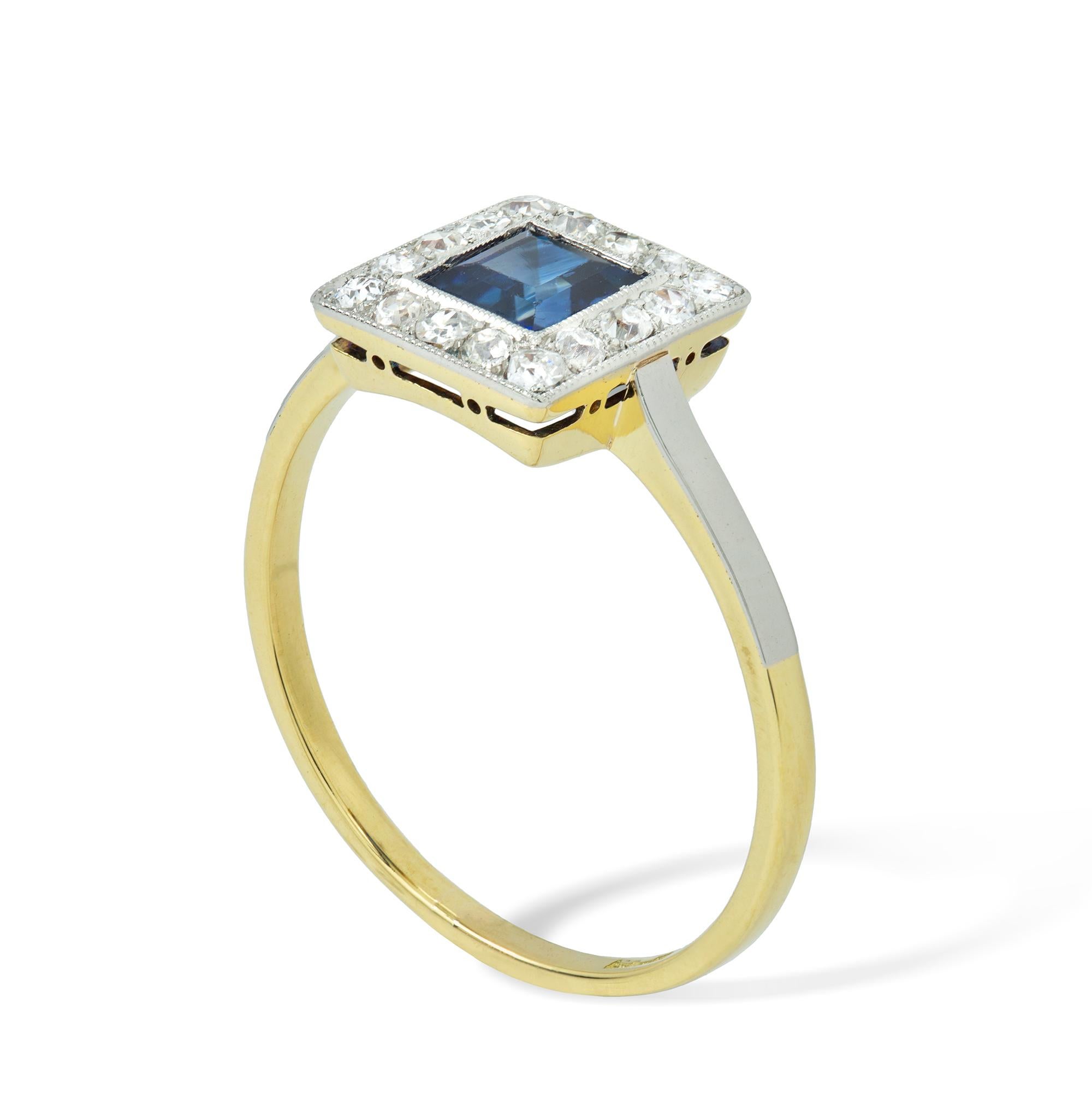 A sapphire and diamond cluster ring, the square sapphire weighing approximately 0.65 carat, surrounded by sixteen old-cut diamonds weighing approximately a total of 0.35 carat, all set in platinum and gold,  circa 1920, head measuring  0.9x0.9cm,