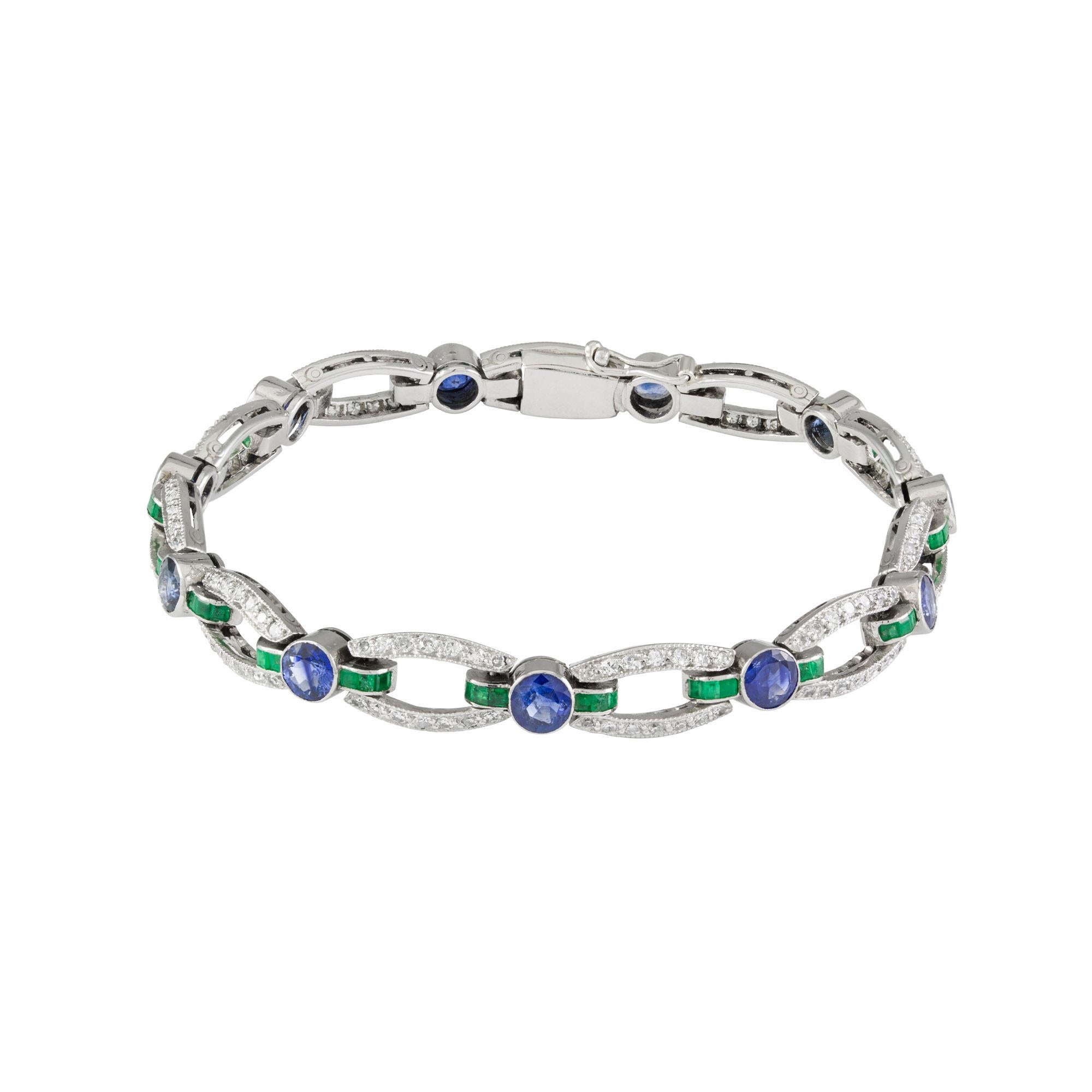 A French Art Deco sapphire, emerald and diamond bracelet, the eleven swiss-cut diamond and square-cut emerald-set open navette-shaped links, the diamonds estimated to weigh 3ct carats in total, the emeralds estimated to weigh 0.7 carats in total,