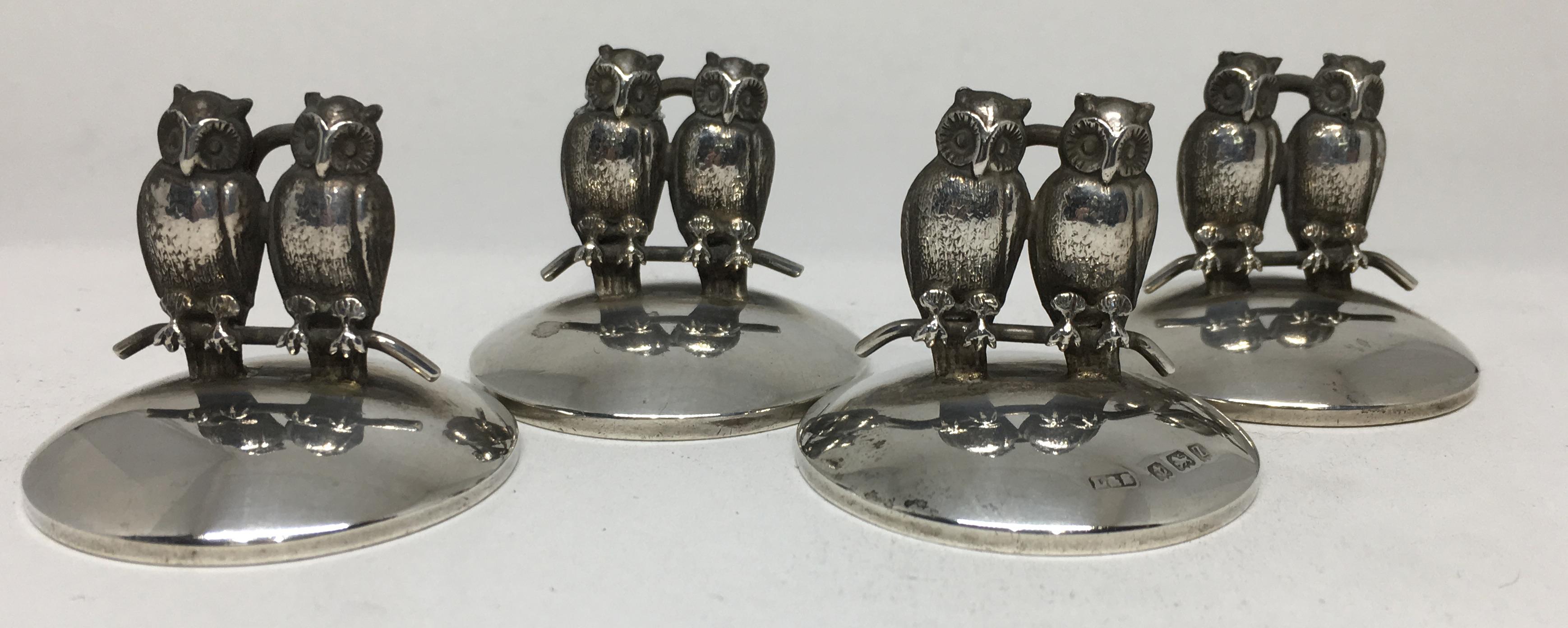 A rare set of four place card holders / menu holders. Each featuring two owls sitting upon a branch.

By Levi & Salamon and dated for Birmingham, 1924.

Each piece measures 1 1/4 inches high.