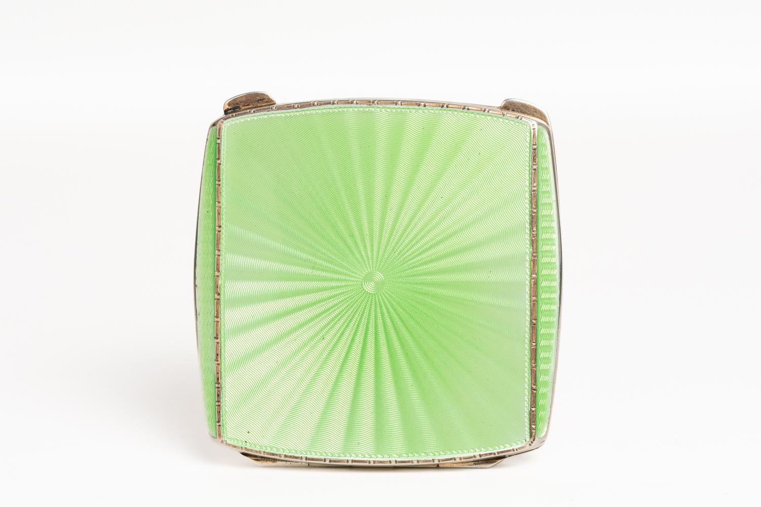 This fine and rare Art Deco green pale guilloche enamel compact was made in Birmingham 1936 and bears the marks of Albert Carter. This square form compact is decorated with a sunburst design, made in a beautiful pale green coloured enamel with a