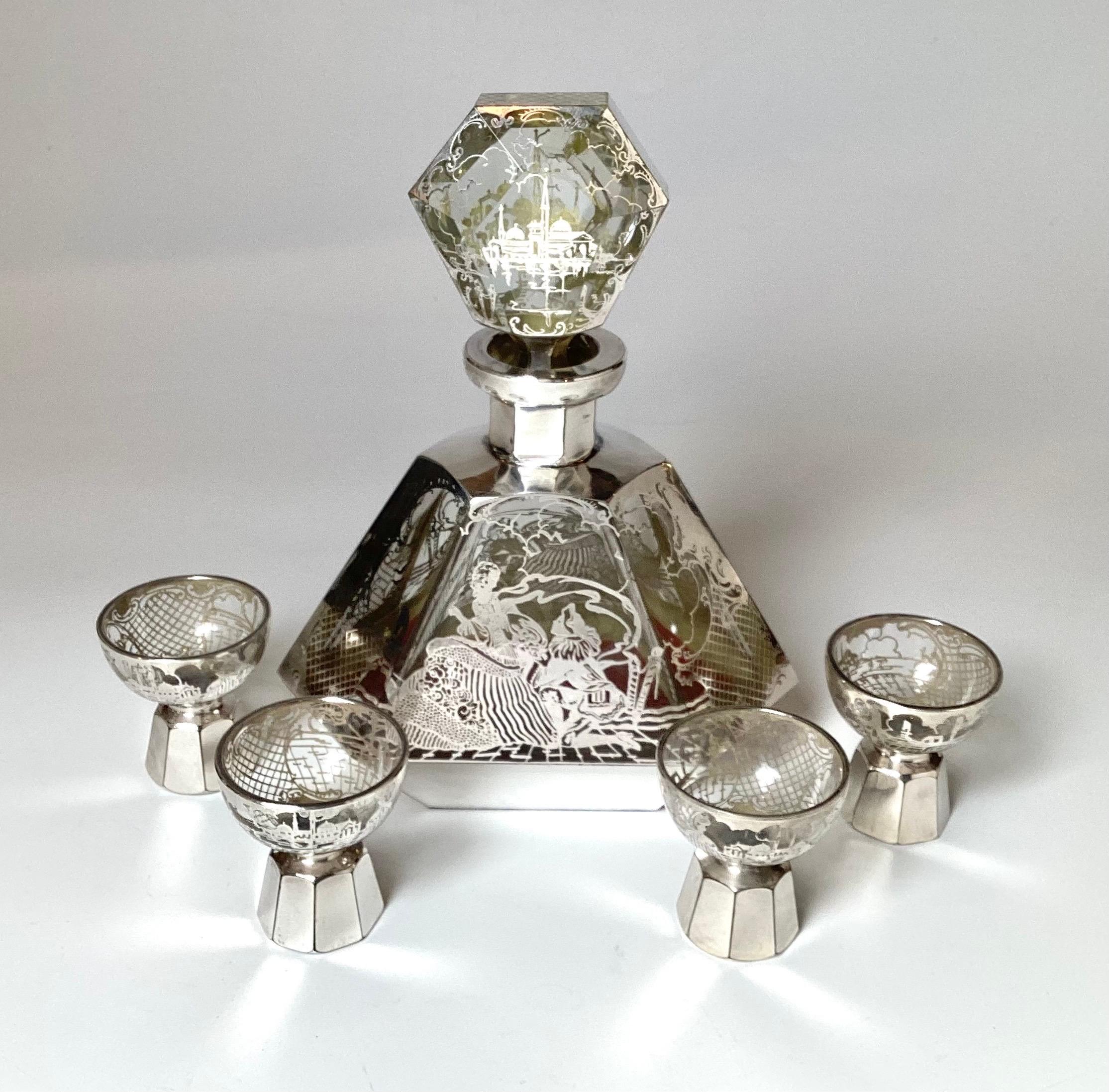 A handsome art deco sterling silver overlay decanter with 4 cordial glasses, original to each other.  The design on each is scenes of Venice, the decanter is 9 inches tall, with the glasses 2.5 inches tall, 