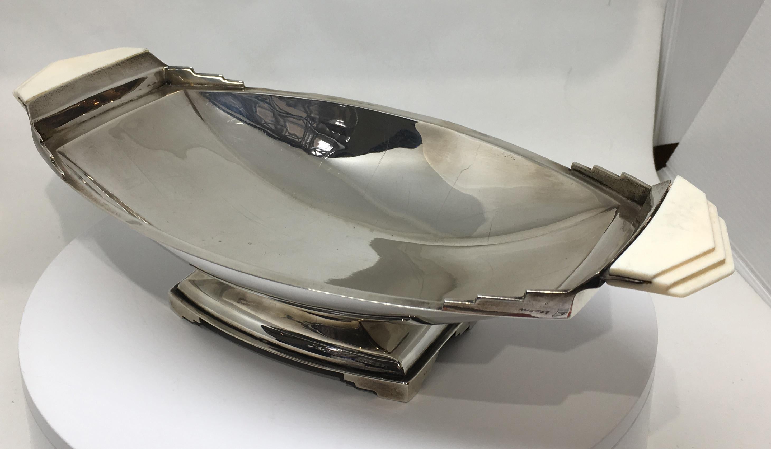 A gorgeous Art Deco sterling silver and carved bone tray / fruit bowl on a stepped base.

Dated for Sheffield, 1936 and in superb condition.

The tray measures 11 inches wide, 5 1/8 inches deep and 3 inches high.