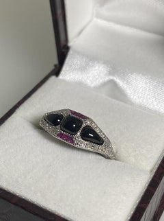 An Art-Deco Style Cabochon Cut Onyx, Ruby & Rose Cut Diamond Gold & Silver Ring