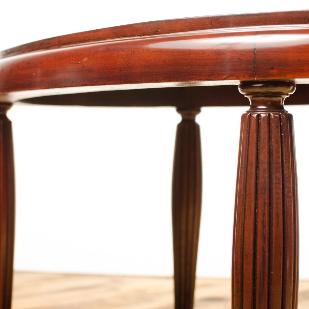 An Art Deco style contemporary table having fluted mahogany legs, American.