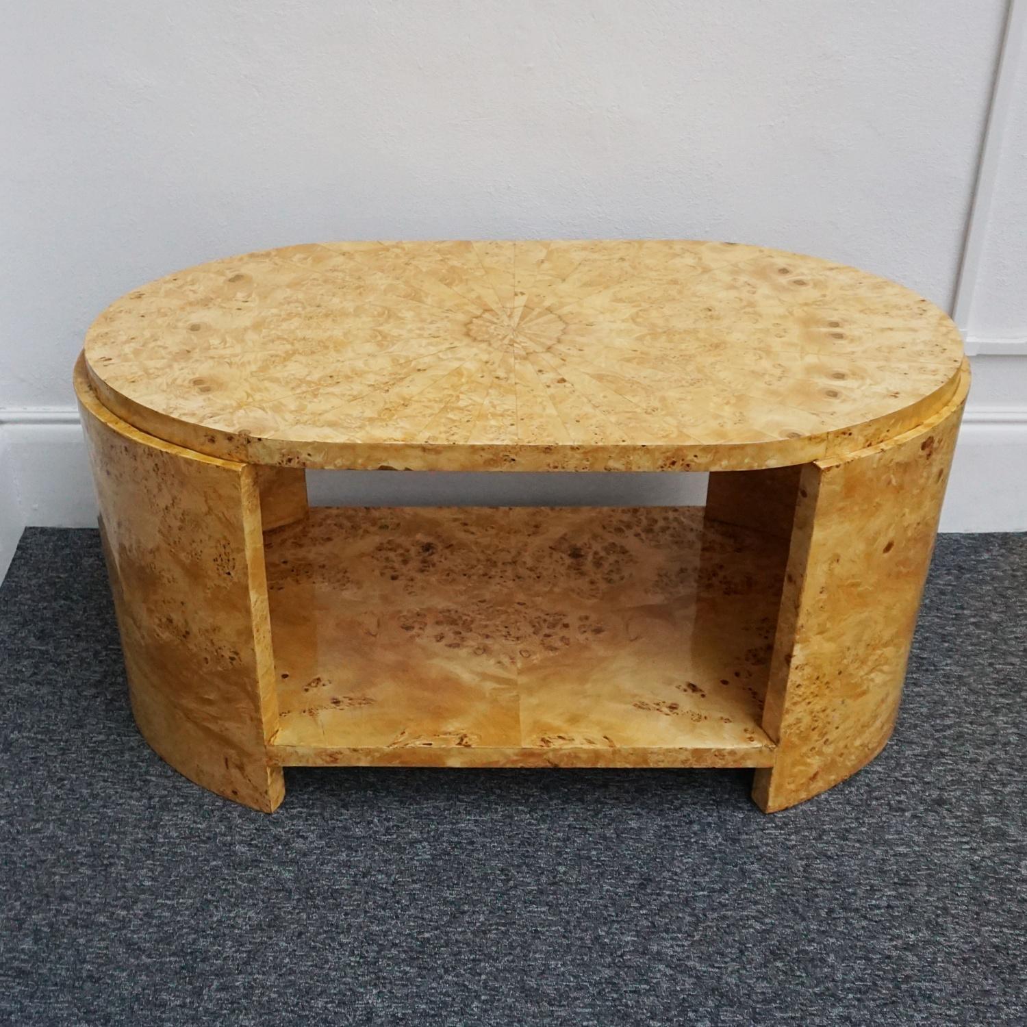 An Art Deco style coffee/centre table. Karelian birch veneered throughout with sunburst table top and lower veneered shelf. 

Dimensions: H 64cm W 120cm D 60cm 

Origin: English

Item Number: 1708222

All of our furniture is extensively