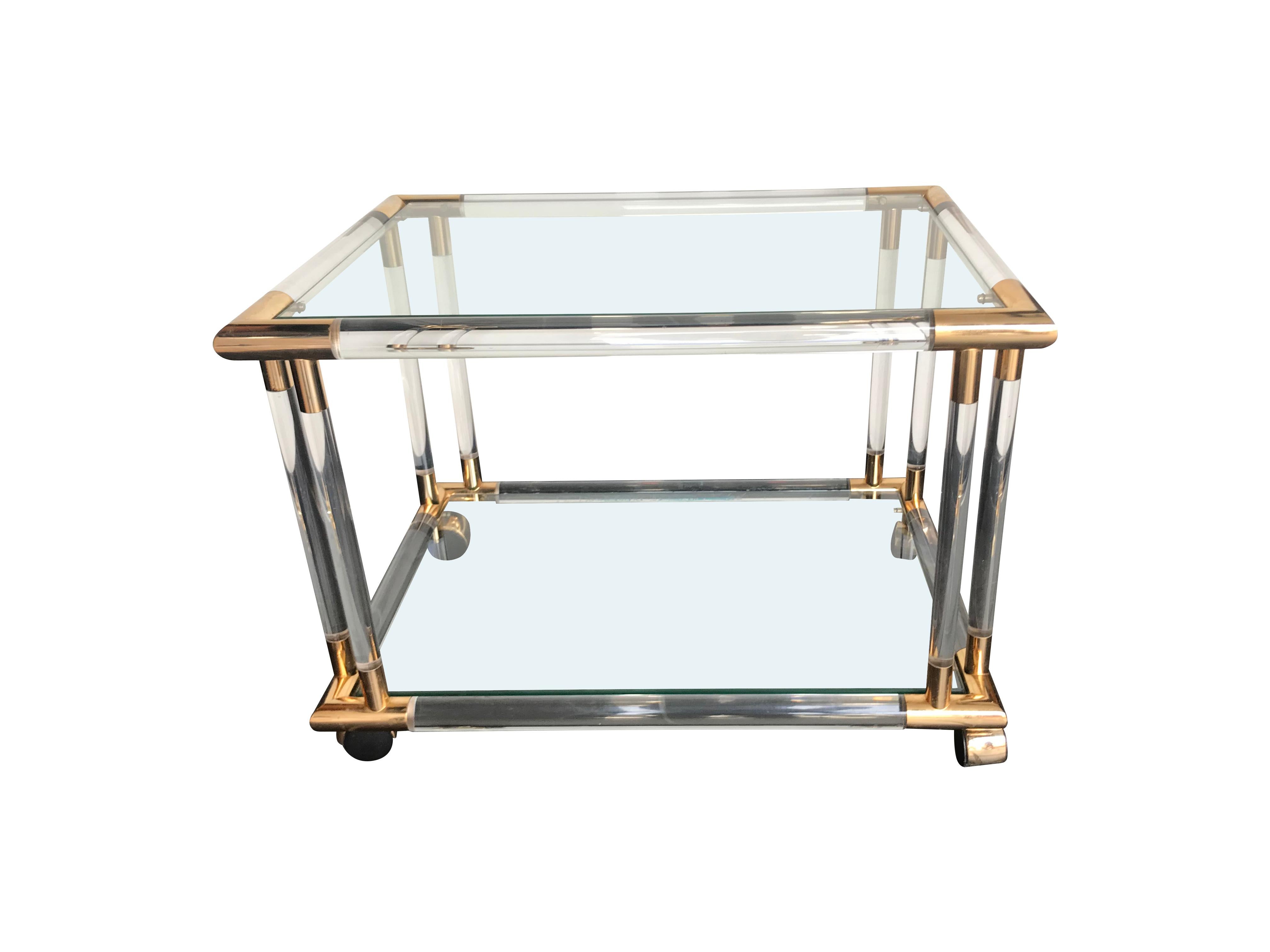 An Art Deco style Lucite and brass bar trolley / side table with 2 glass shelves, on brass castors. A lovely quality made piece with thick Lucite frame.