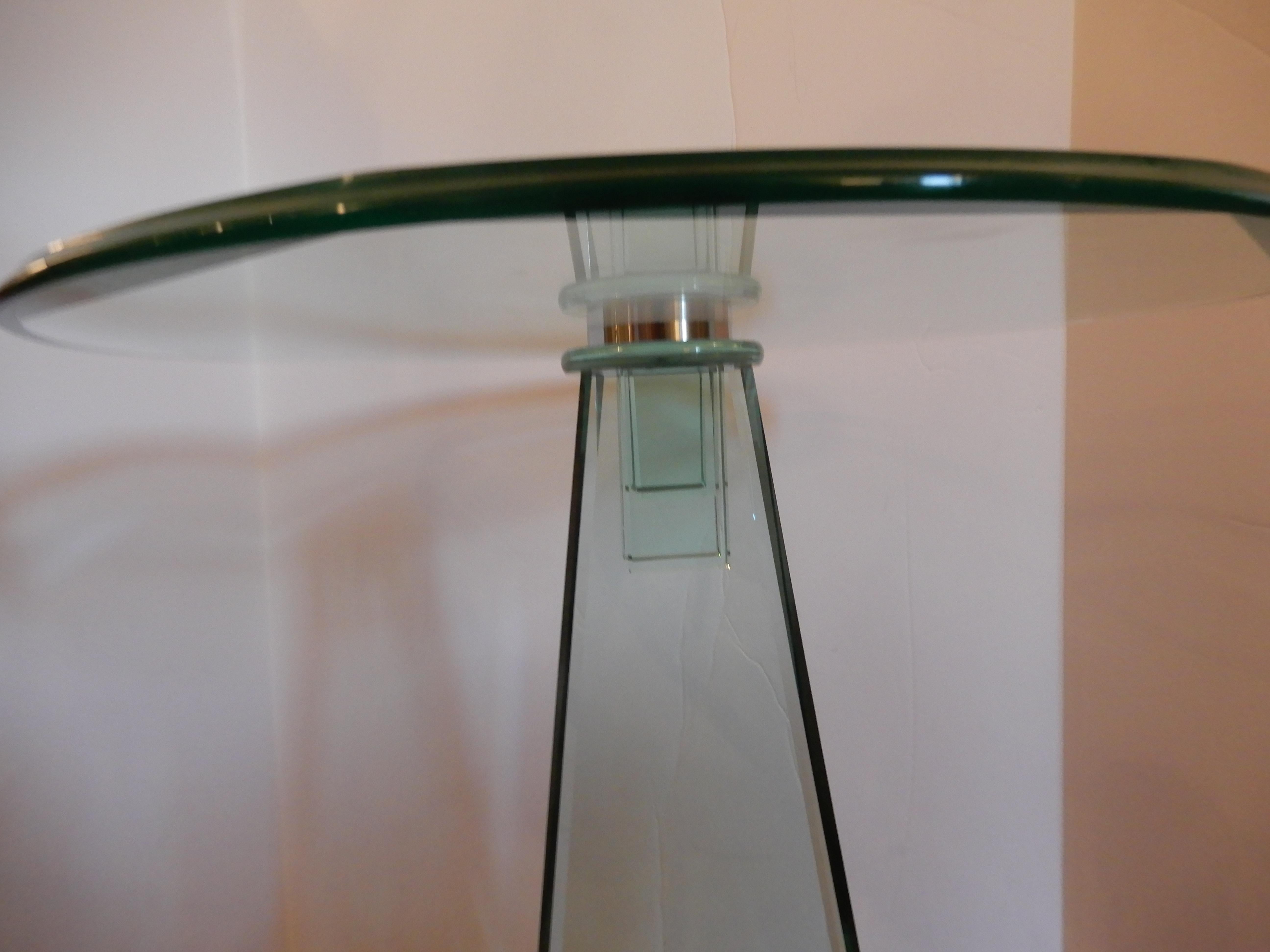 An Art Deco styled side or end table in the school of Danny Lane. The glass is triple beveled with finest craftsmanship, an Art Deco form column with chrome steel spheres on bottom plate, top glass adheres to a steel plate.