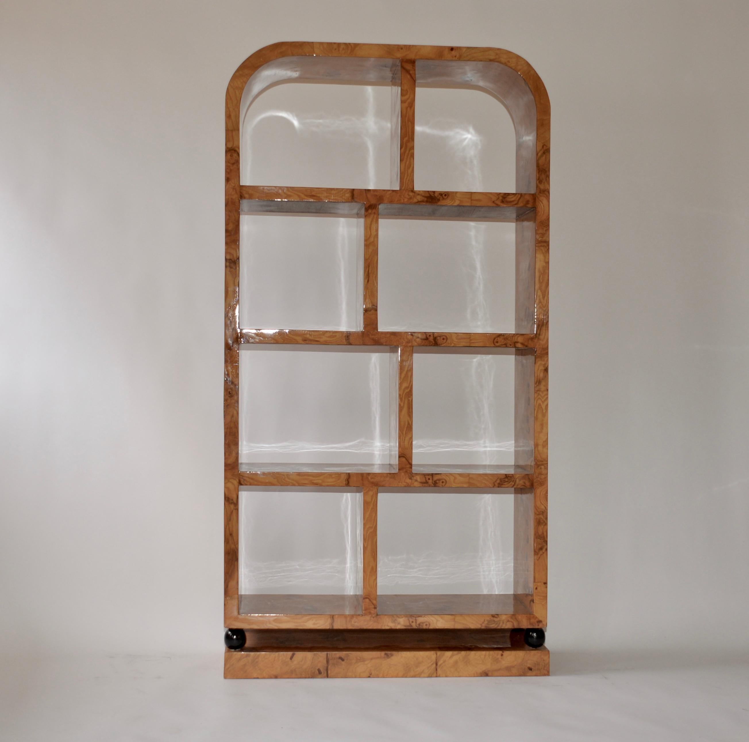 An Art Deco style walnut veneered shelving / display unit. Five shelves and in fabulous original condition and a very striking piece.