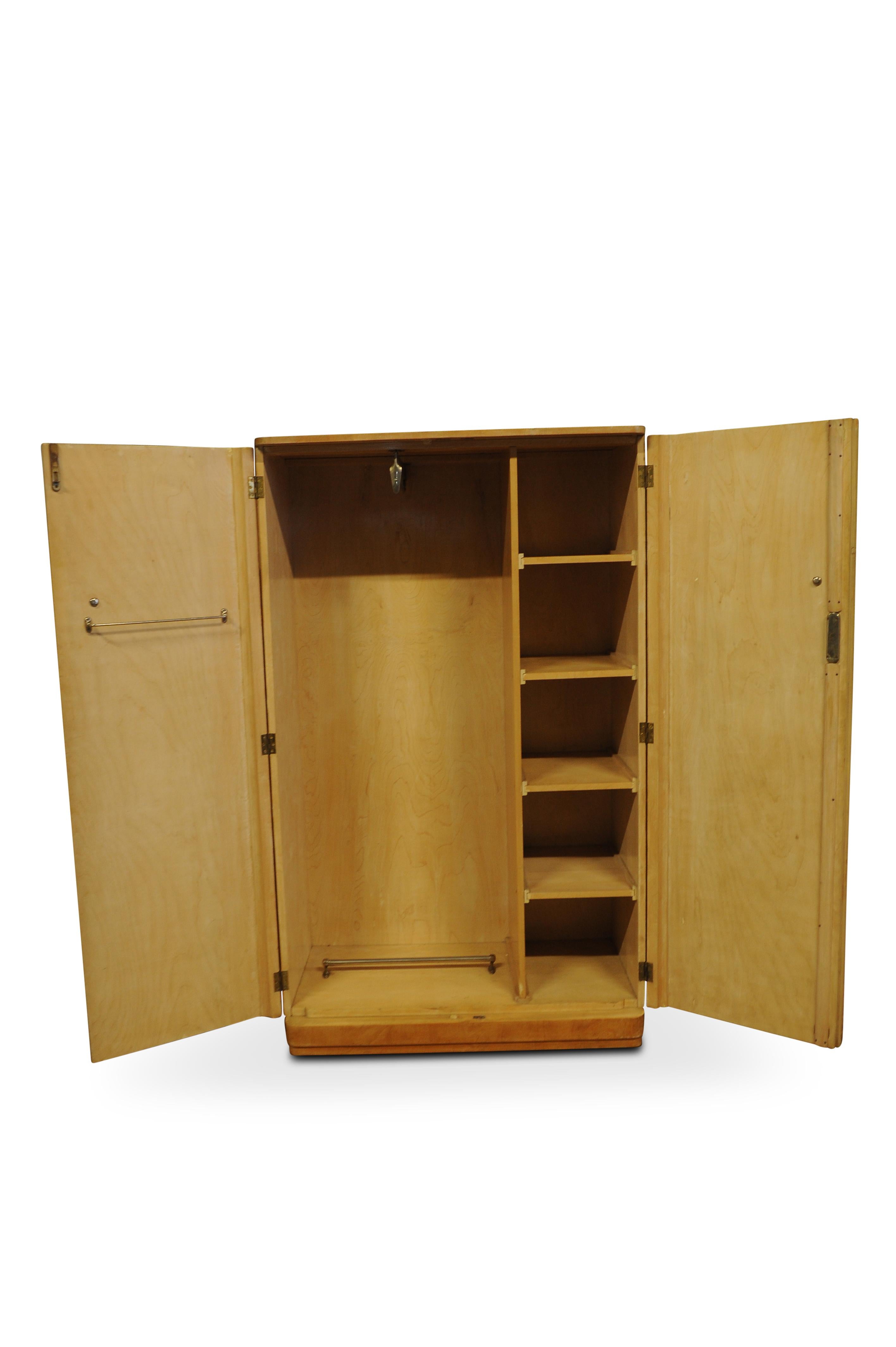A 1930s Art Deco burr walnut figured two door wardrobe or armoire with original fittings.

A fine example of Art Deco 1920s-1930s furniture with the luxury interior all original fittings remain intact. Pull out bar for hanging clothes, separate
