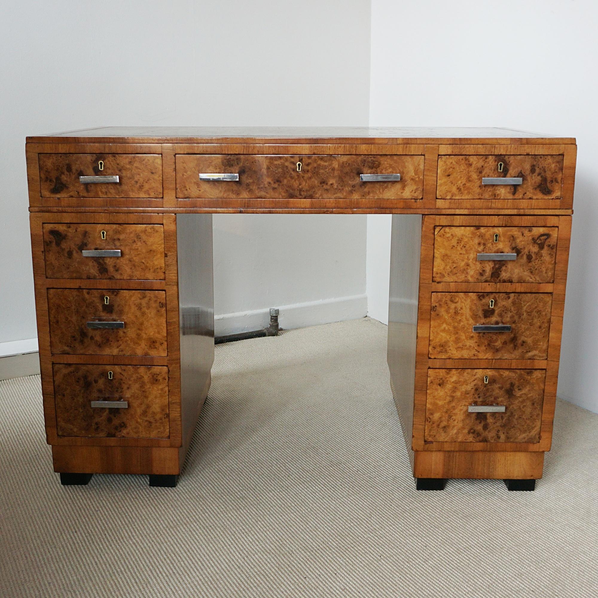 An Art Deco writing desk attributed to Heal's of London. Burr walnut veneered with figured walnut banding and original leather scriver. Original chrome handles. 

Dimensions: H 75cm W 106cm D 58cm

Founded by John Harris Heal 1810, Heal’s London has