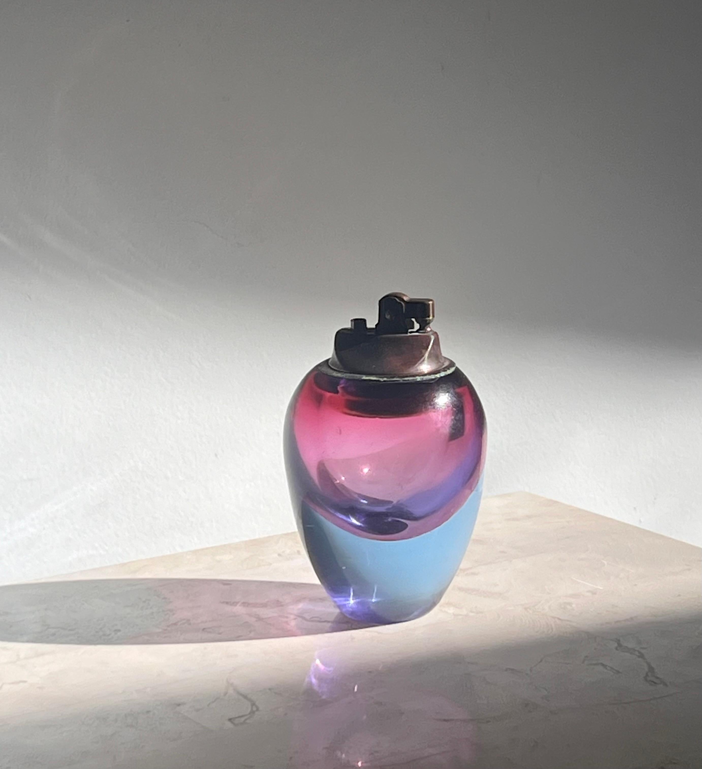 A vintage Italian art glass lighter by Murano, design attributed to Flavio Poli, circa 1950 - 1960. In tones of violet, azure, and hibiscus pink.
I had this piece appraised and authenticated by an expert vintage Italian glass collective: they deemed