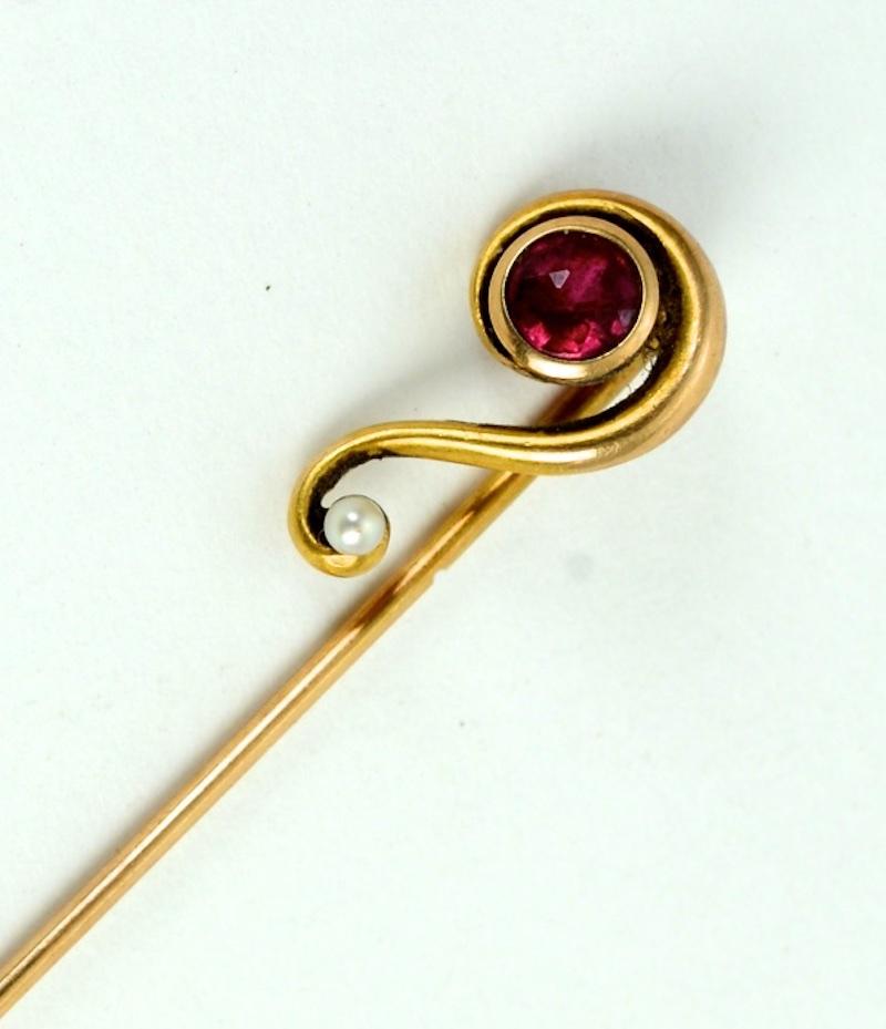 An Art Nouveau 14K Yellow Gold, Ruby and Seed Pearl Stick Pin. The ruby is a round, full cut .25 carat bezel in a bezel setting. The setting is hallmarked 14K.
N.P. Trent has been a respected name in antiques for over 30 years with a large