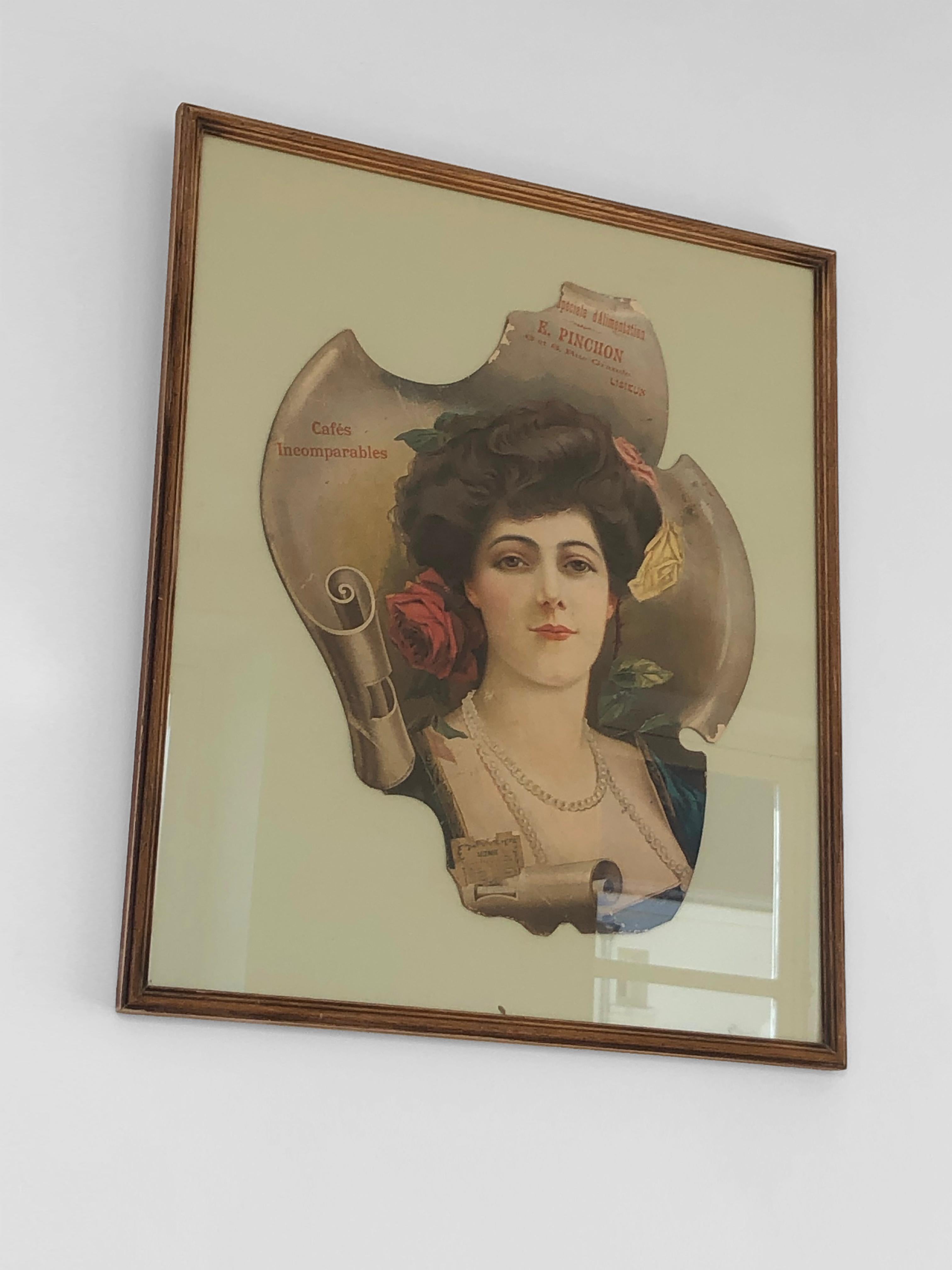 An elegant poster for a grocery store in Lisieux, featuring a woman's portrait and various information on free-form paper cutouts, to be attributed, France 1900. The entire piece is mounted on a pale green paper background and presented in a wooden