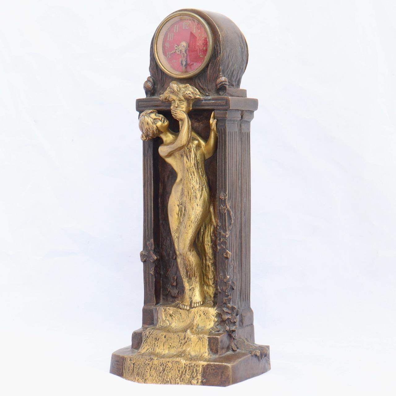 Charles Korschann (1872-1943) 
An Art Nouveau bronze table clock
Gilt and patinated bronze, modelled as a nude female, her hand over the opening of a 
fountainhead, with water rushing down her body, flanked by columns with vines, all beneath a