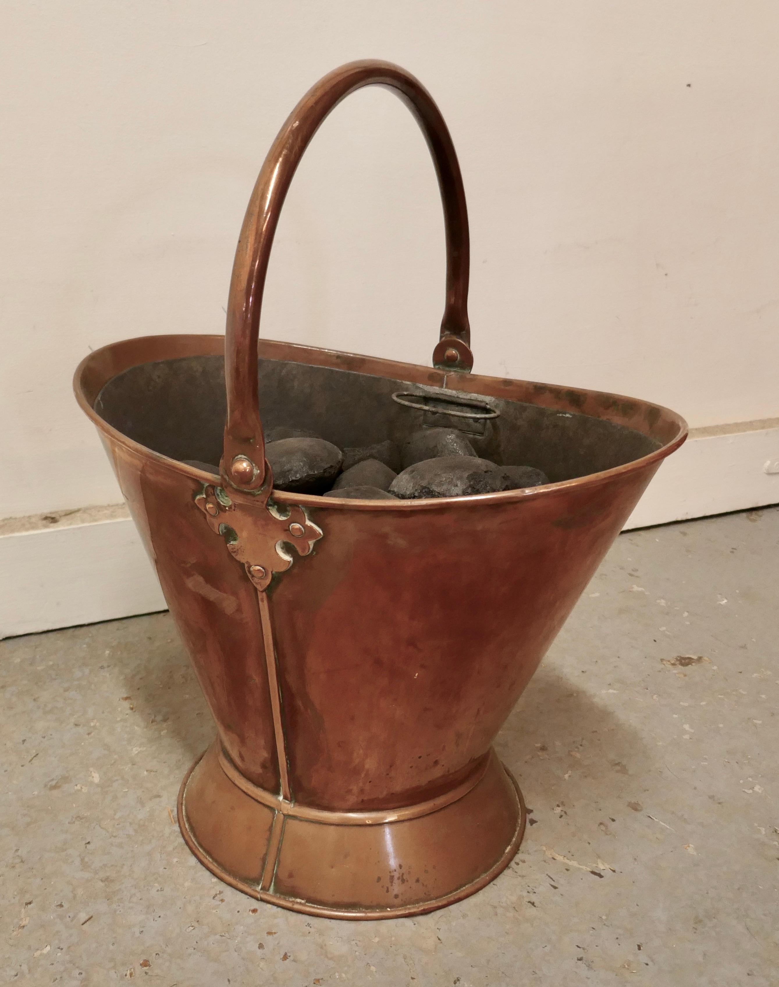 An Art Nouveau copper helmet coal scuttle with liner

This is a very attractive bucket is has an open Oval shape with upward sweeping sides, it has a swing handle and a 2 handled lift out liner 
The Scuttle is in very good used condition, and is