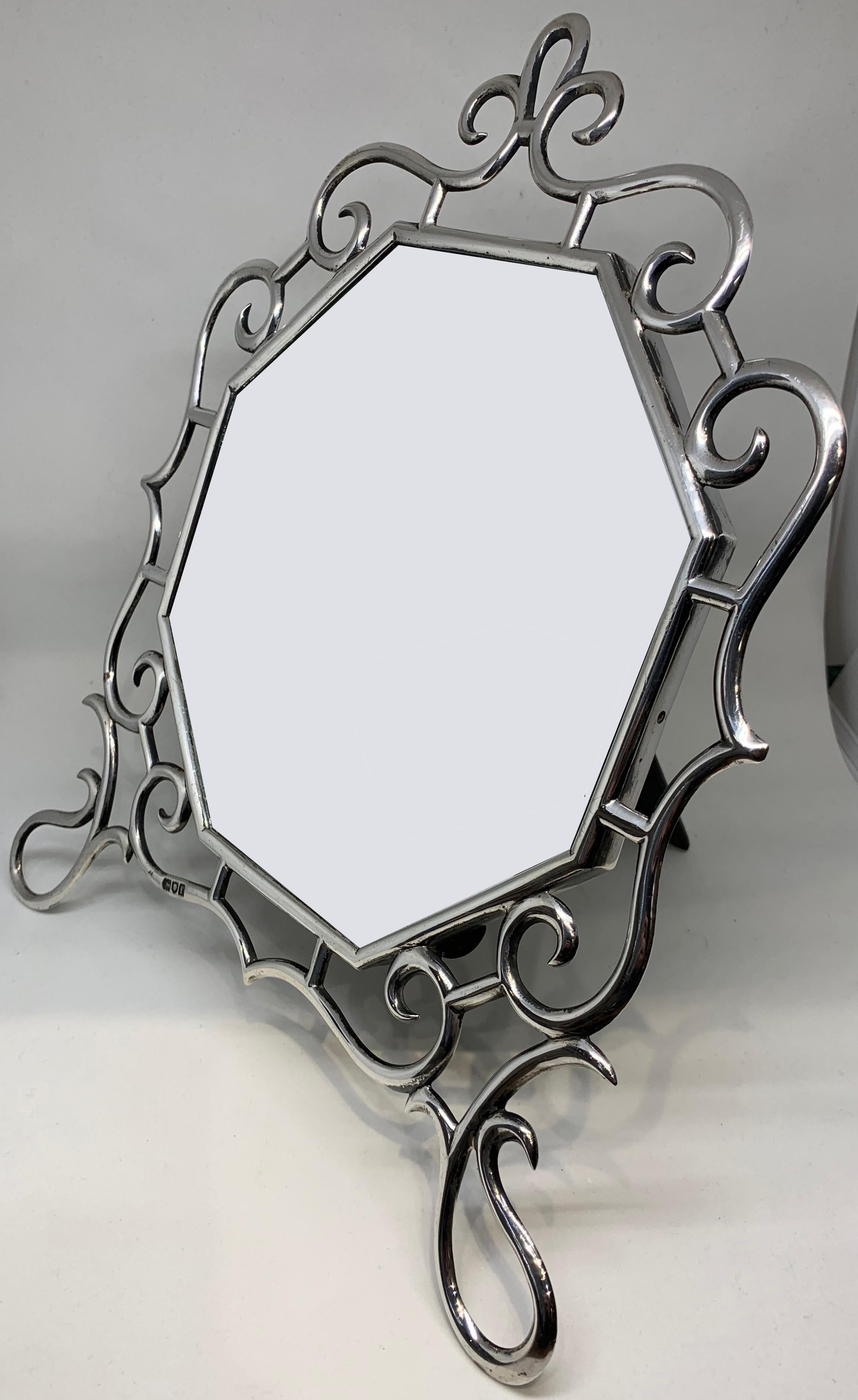 A highly stylised Art Nouveau sterling silver dressing table mirror dated for London 1901.

Measuring 11 inches wide and 12.5 inches tall. The octagonal mirror measures 7.5 inches straight across the centre.

The makers mark is rubbed but the