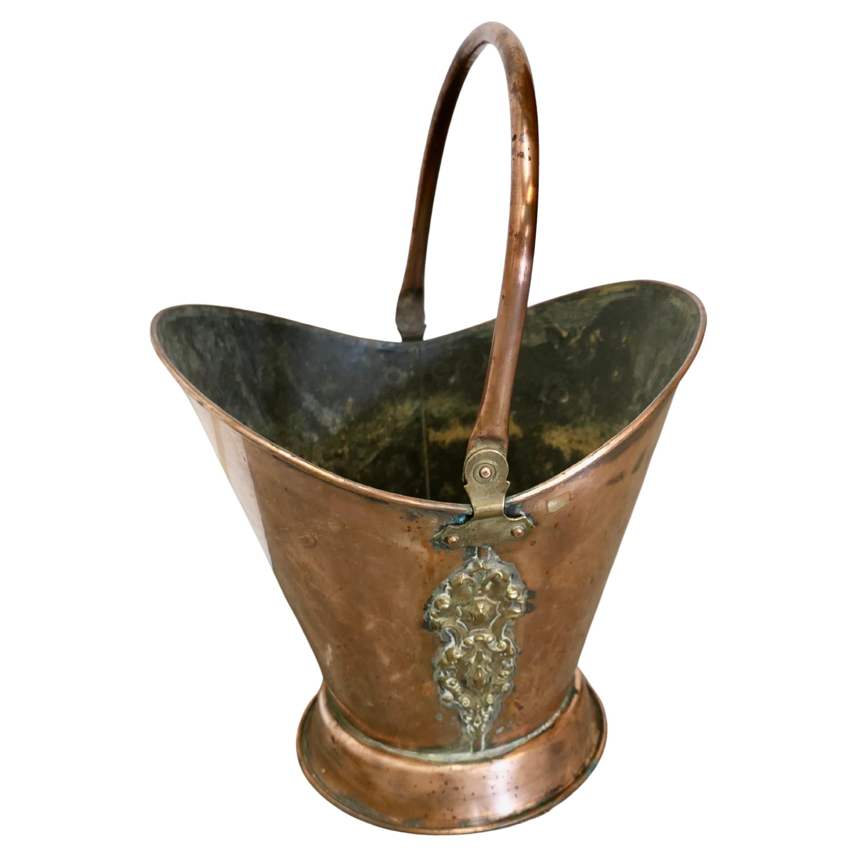 An Art Nouveau Embossed Copper Helmet Coal Scuttle For Sale