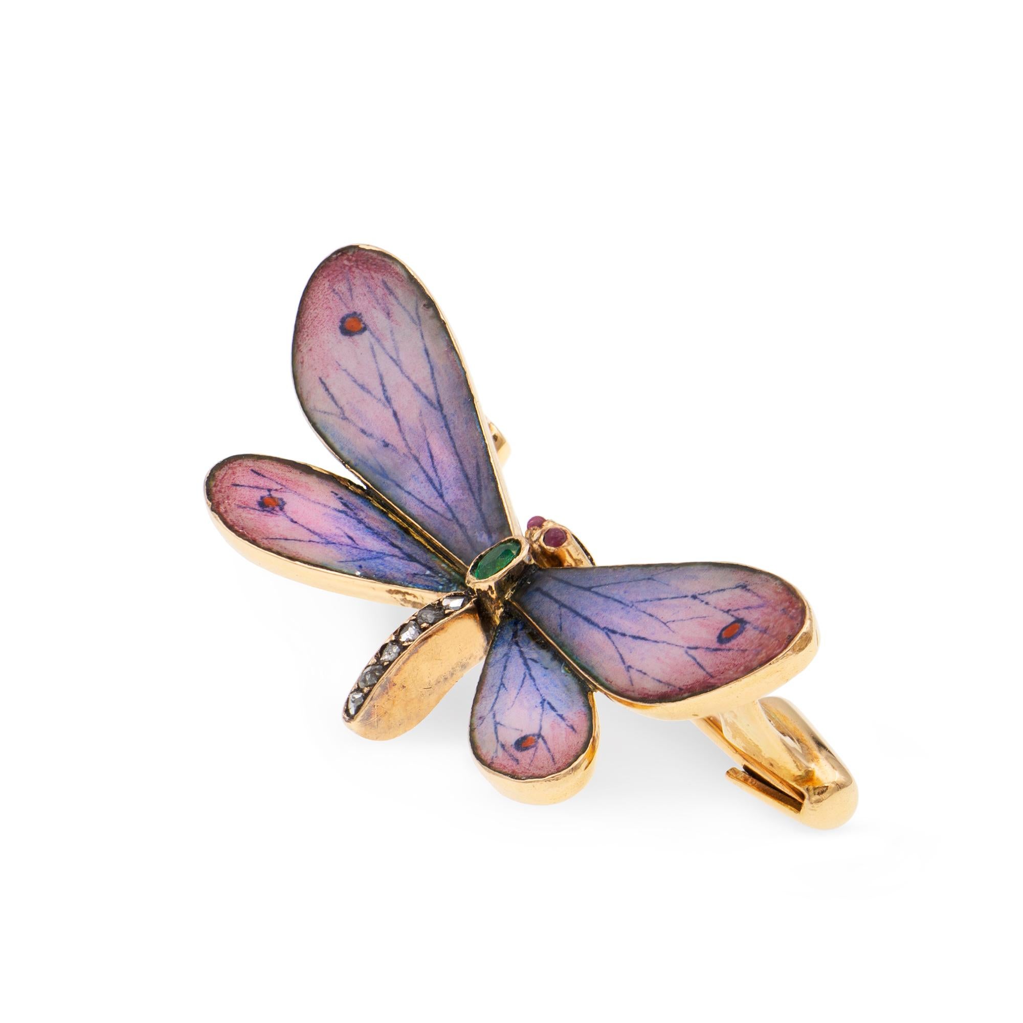 An Art Nouveau enamel and diamond butterfly brooch, the wings embellished with pink and purple enamel, the body set with rose-cut diamonds and an oval-shaped faceted emerald, with cabochon ruby eyes, all set to a yellow gold mount and brooch