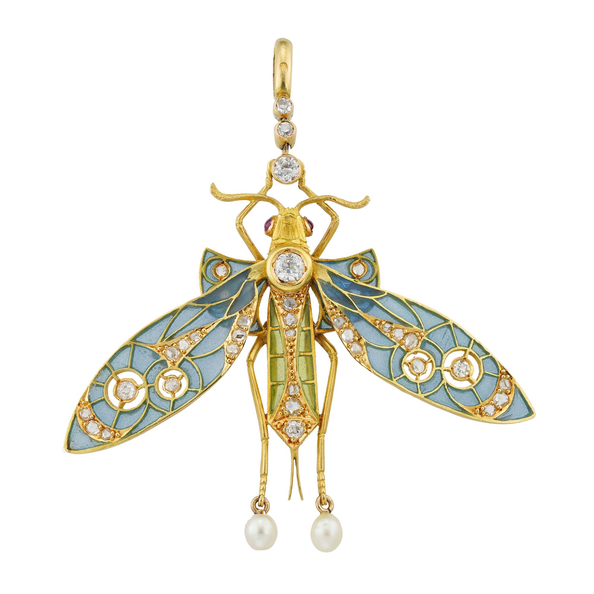 An Art Nouveau enamel and diamond dragonfly pendant, the body set with old European and rose-cut diamonds, and bearing green plique-à-jour enamel decorations, the head  with two cabochon-cut ruby-set eyes, the bottom legs terminating to two drop